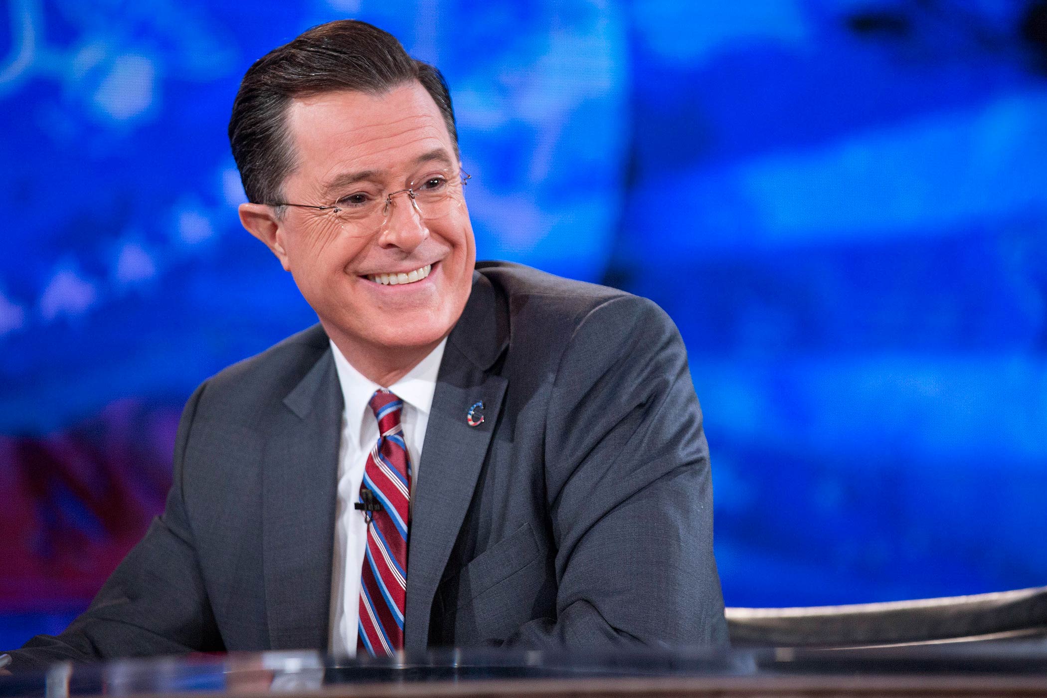 Stephen Colbert smiles while taping "The Colbert Report" with President Barack Obama, not pictured, in Lisner Auditorium at George Washington University in Washington on Dec. 8, 2014.