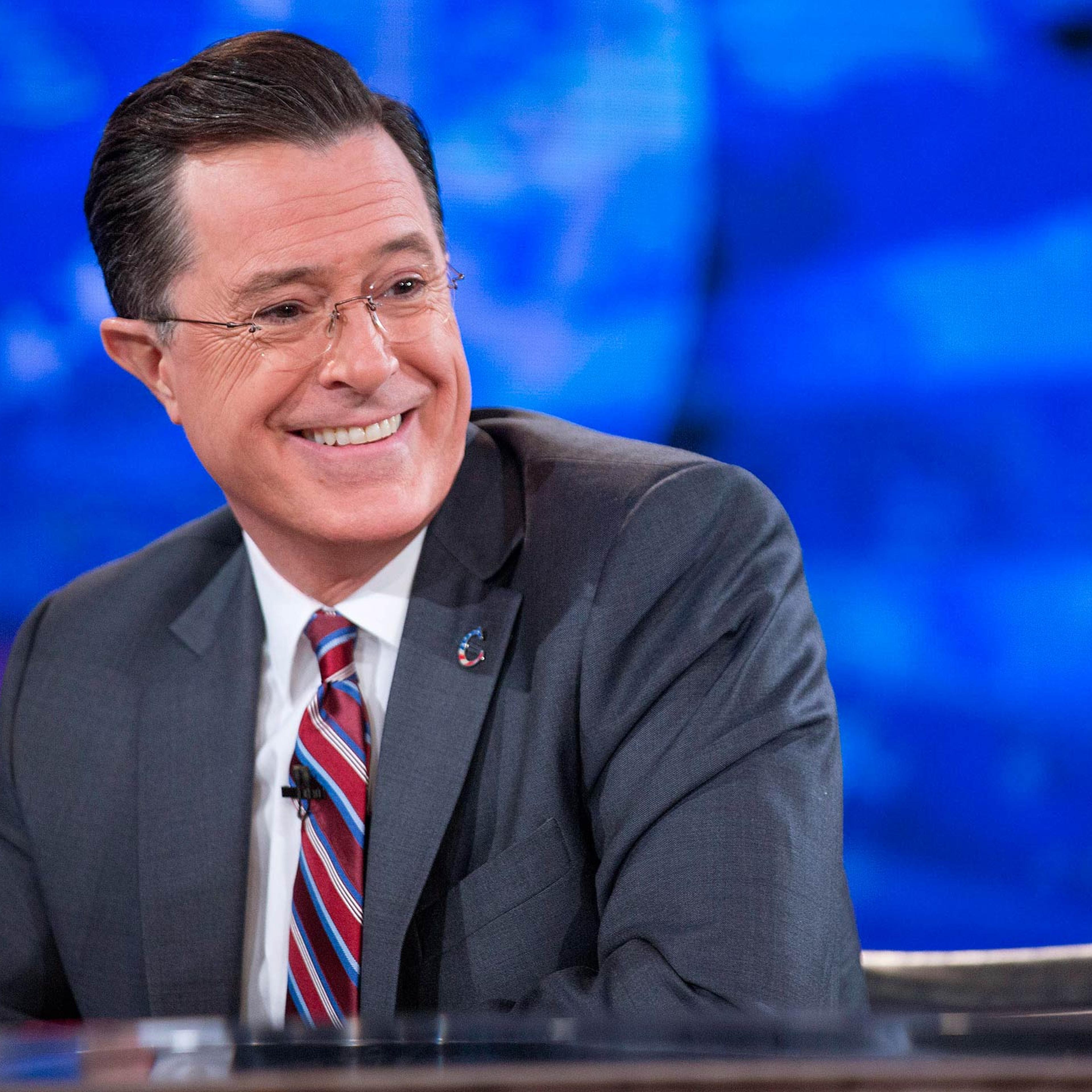 Stephen Colbert smiles while taping "The Colbert Report" with President Barack Obama, not pictured, in Lisner Auditorium at George Washington University in Washington on Dec. 8, 2014.