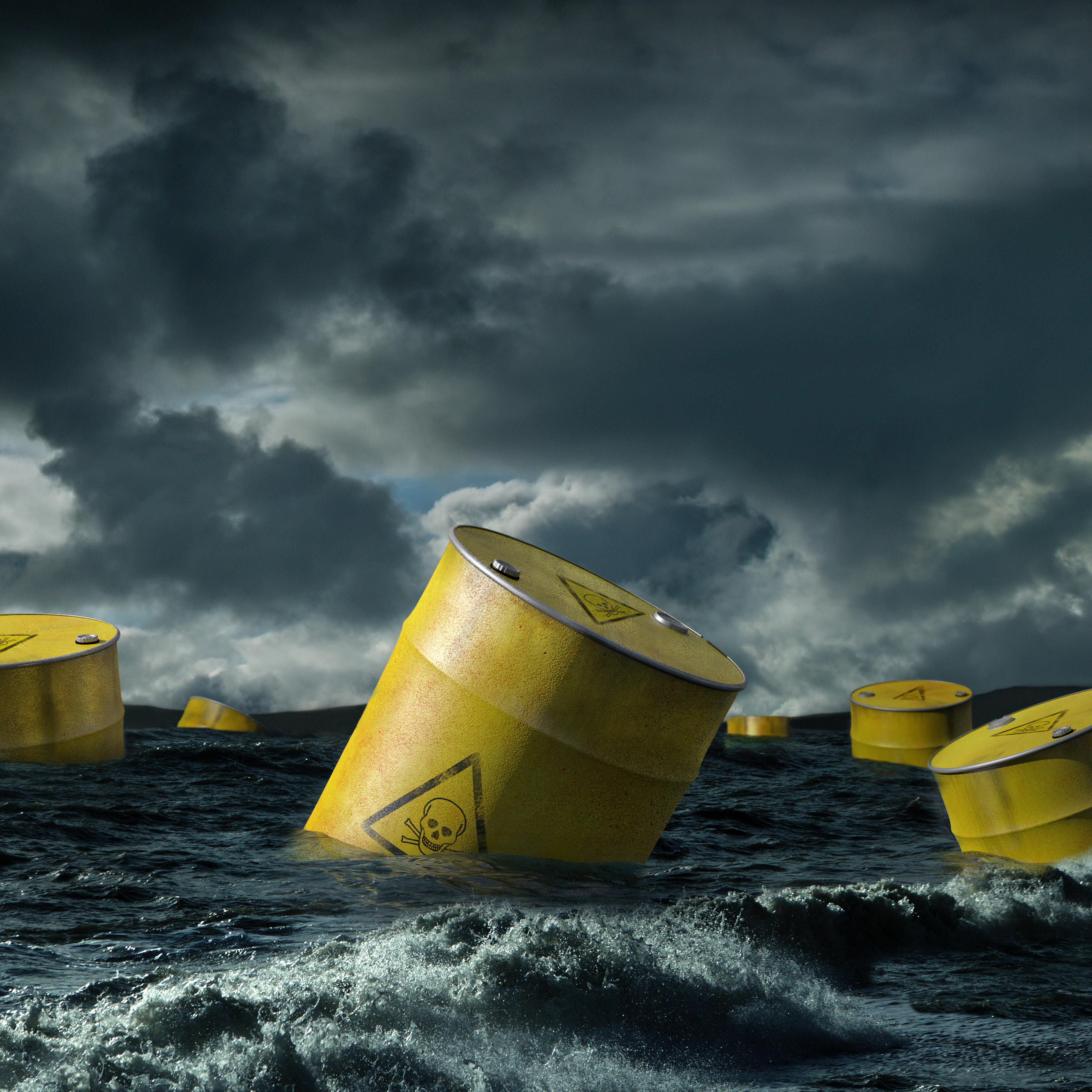 Oil barrels floating in stormy sea
