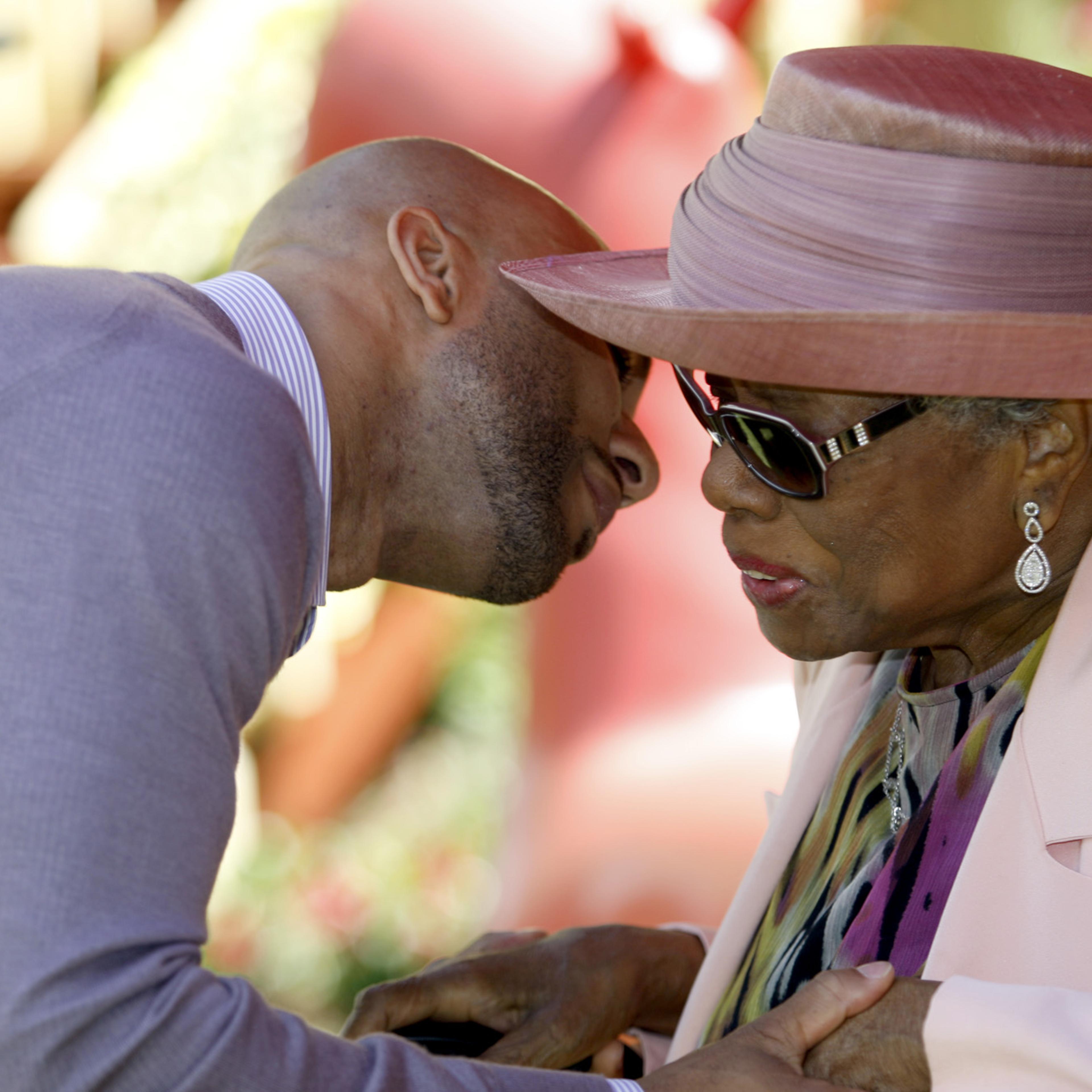 Common greets Maya Angelou at a garden party at Angelou's home in 2010.