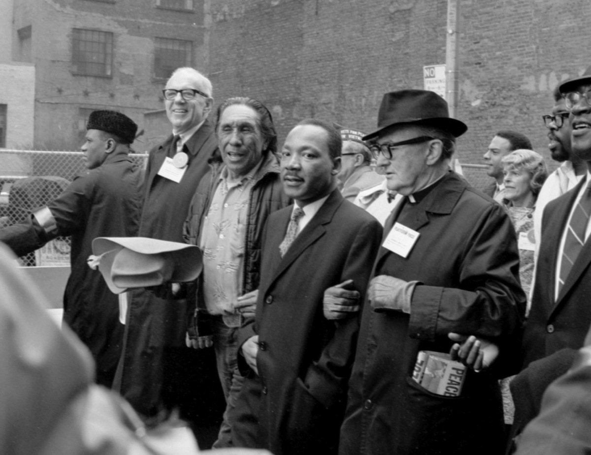 Martin Luther King Jr. marching in Vietnam protest parade.