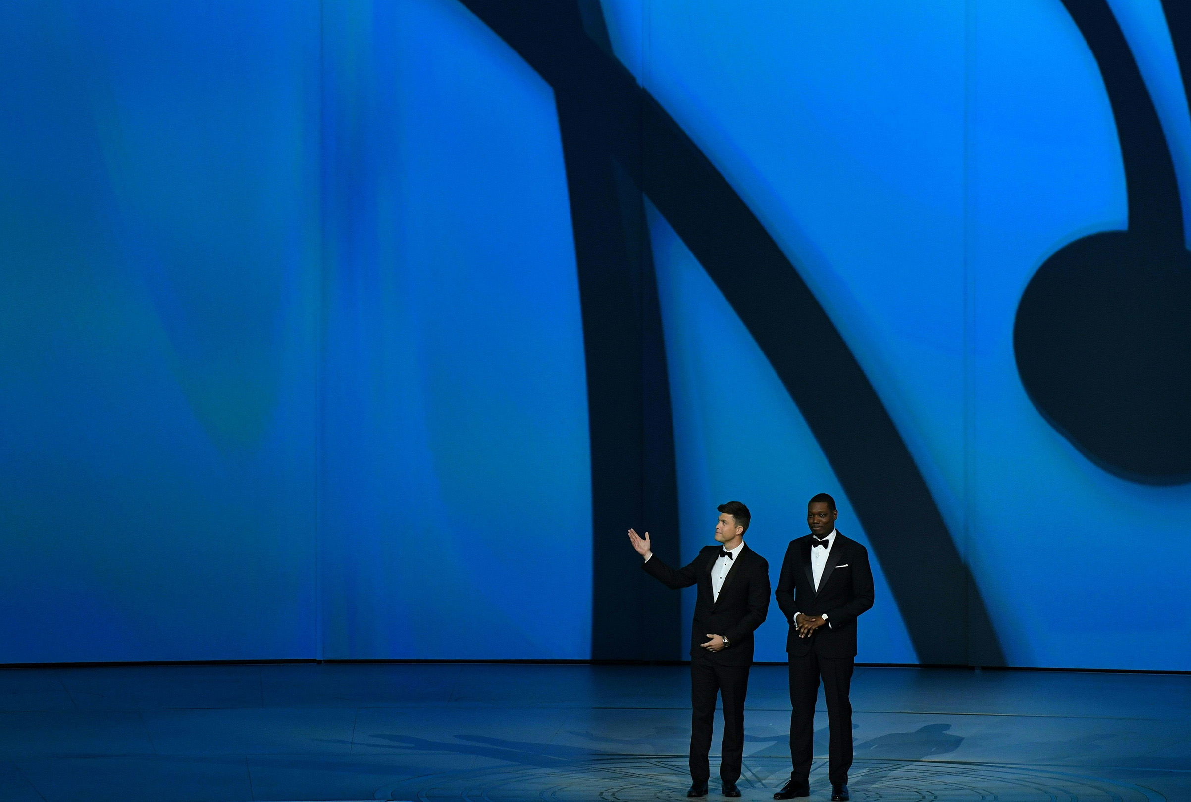 Host Colin Jost and Michael Che speak onstage during the 70th Emmy Awards at the Microsoft Theatre in Los Angeles on Sept. 17, 2018.