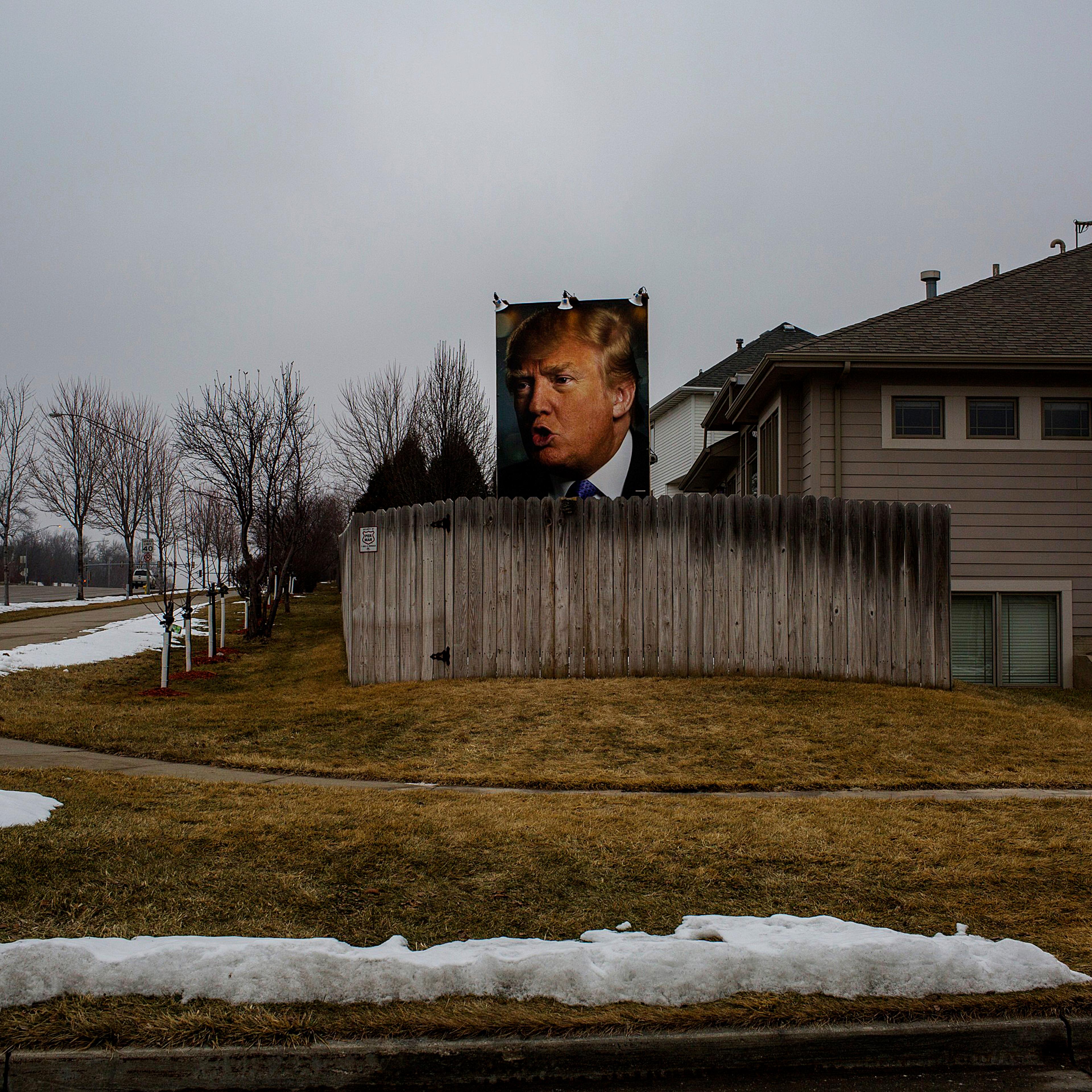 A poster depicting Republican Presidential candidate Donald Trump is mounted on a lawn in West Des Moine, Iowa, on Jan. 25, 2016.