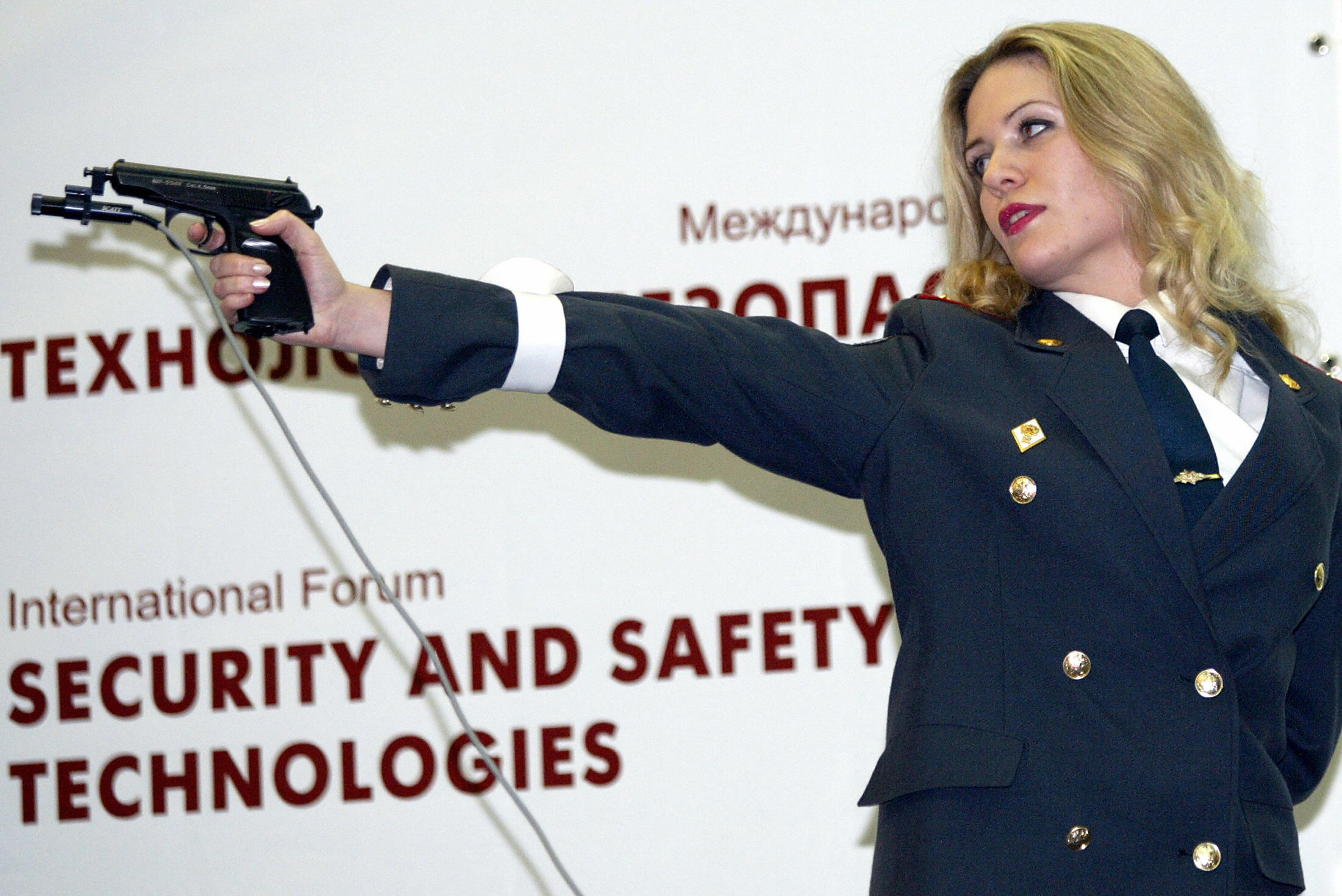 A Russian policewoman shoots during a "M