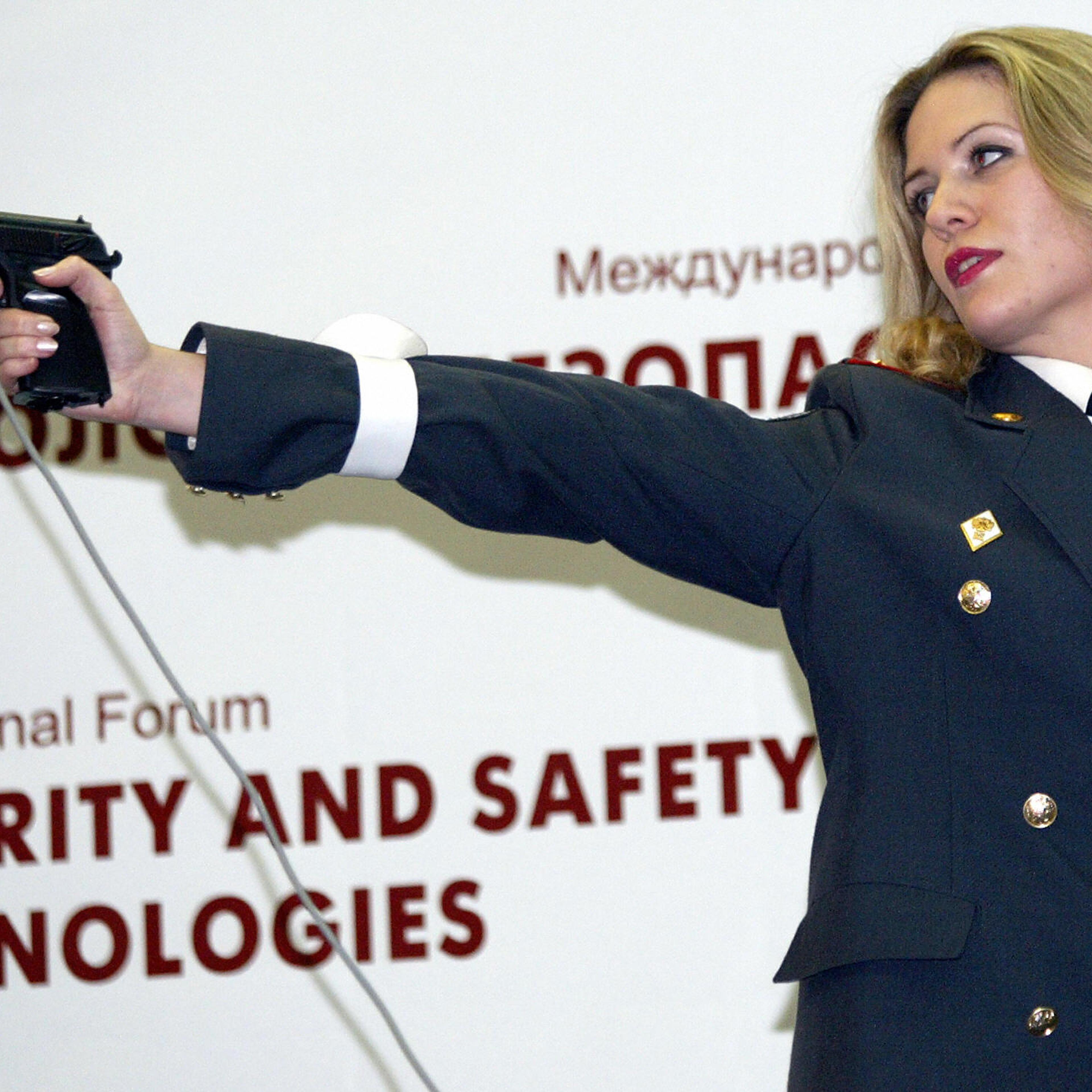 A Russian policewoman shoots during a "M