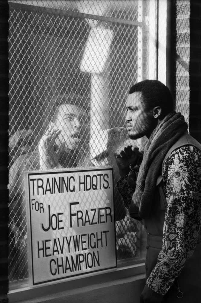 Challenger Muhammad Ali taunts heavyweight champ Joe Frazier at Frazier's training camp in Pennsylvania ahead of their March 1971 "Fight of the Century" title bout at Madison Square Garden. Frazier retained the championship belt in a unanimous 15-round d
