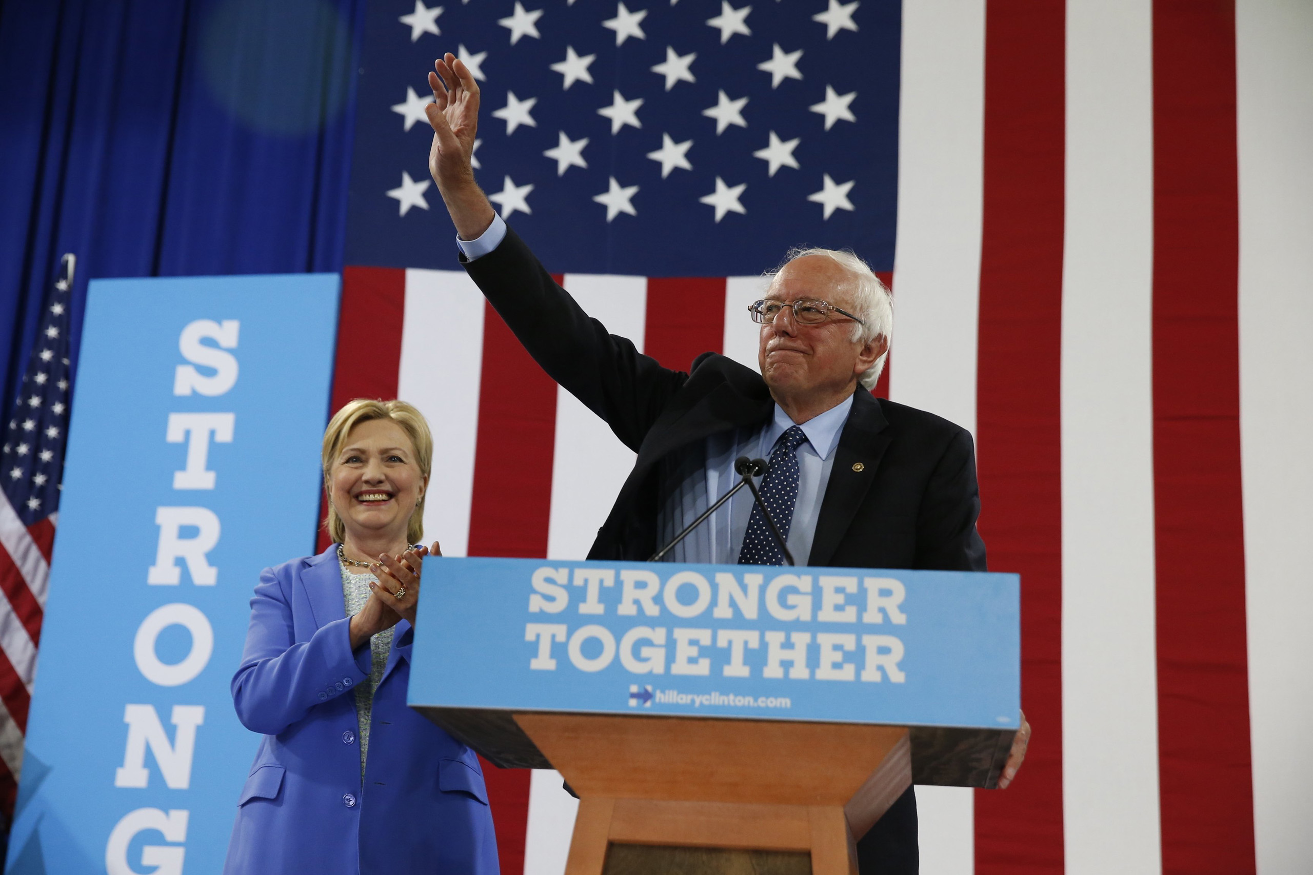 Sen. Bernie Sanders, I-Vt. waves as he a Democratic presidential candidate Hillary Clinton arrive for a rally in Portsmouth, N.H., Tuesday, July 12, 2016.