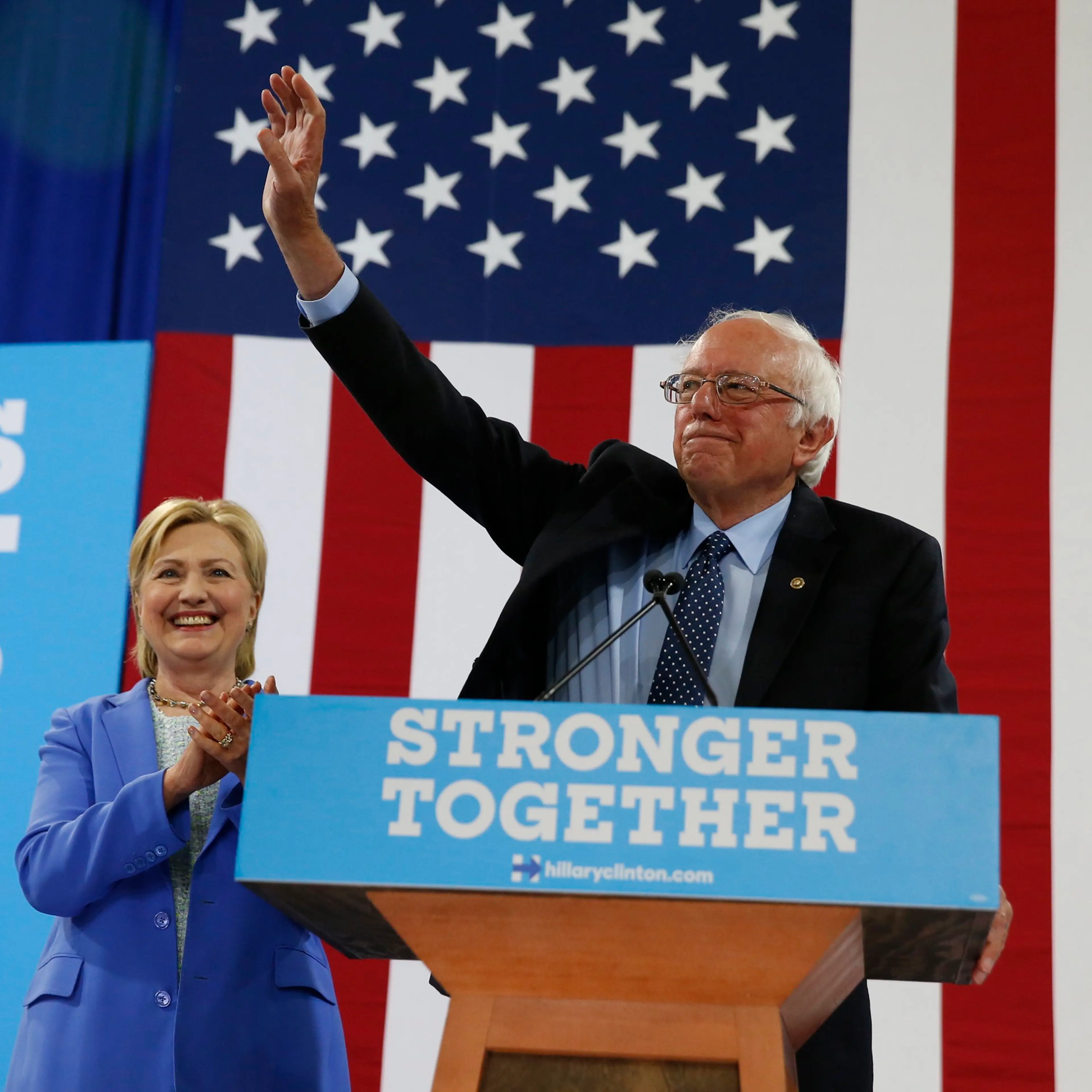 Sen. Bernie Sanders, I-Vt. waves as he a Democratic presidential candidate Hillary Clinton arrive for a rally in Portsmouth, N.H., Tuesday, July 12, 2016.