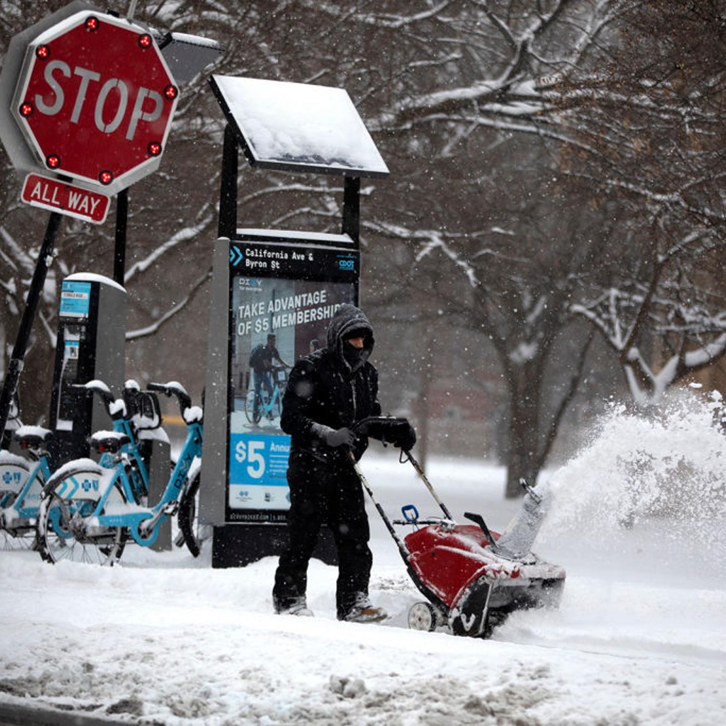 Snow is removed from the sidewalk in front of the McFetridge Sports Center in Chicago