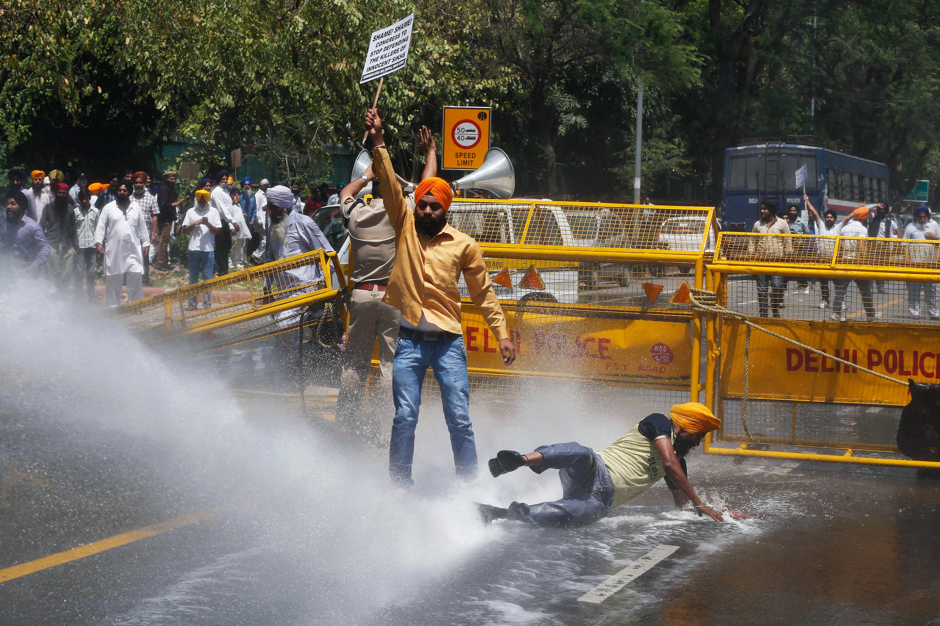 Police use a water cannon to disperse Sikh protesters during a demonstration in front of India?s ruling Congress party headquarters in New Delhi
