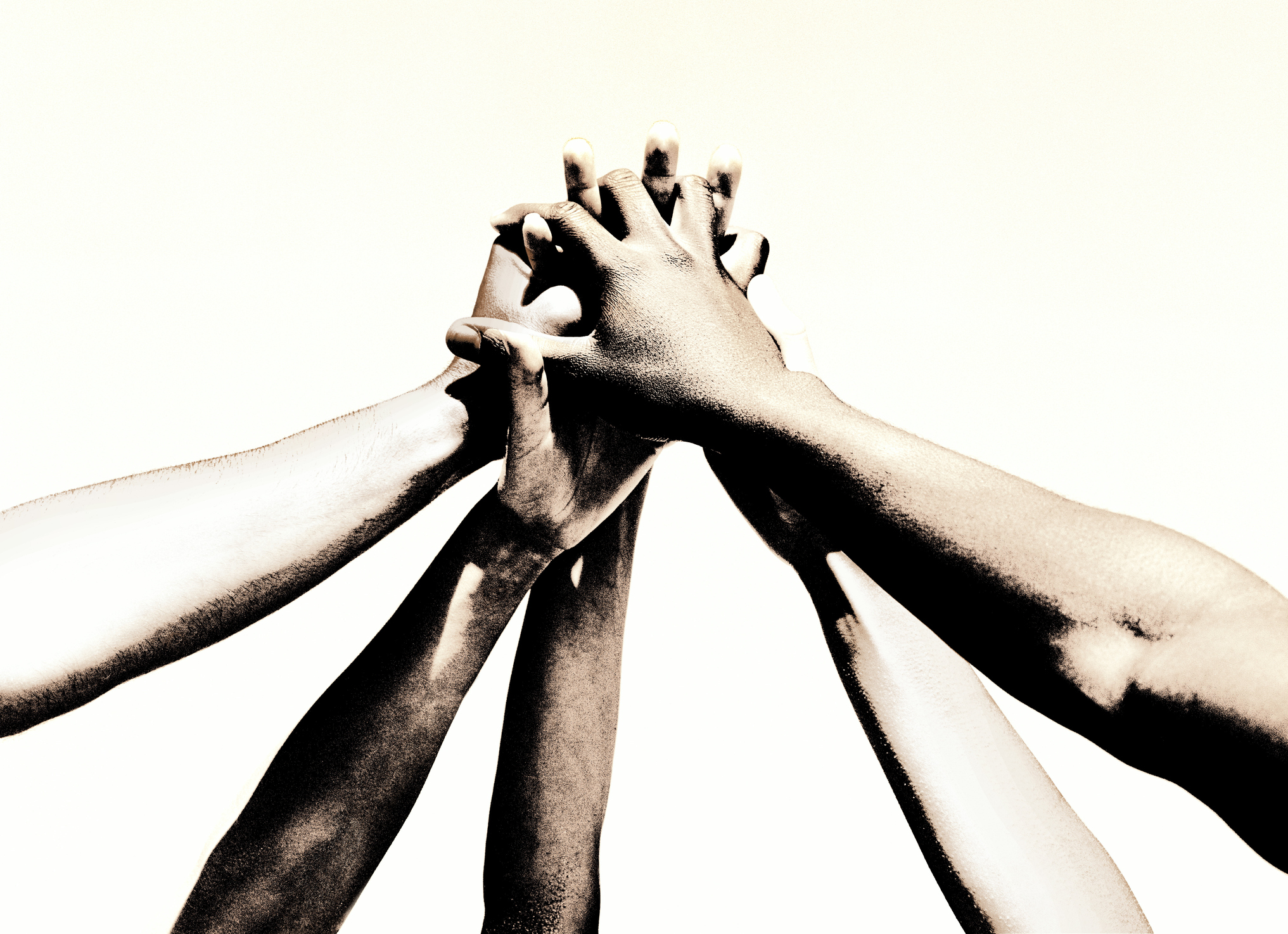 Group of young people's hands clasped together