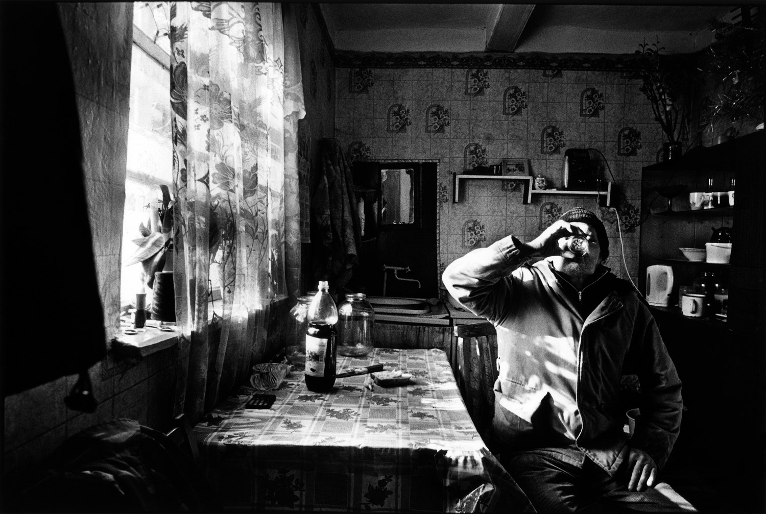 A villager drinks home-made wine.