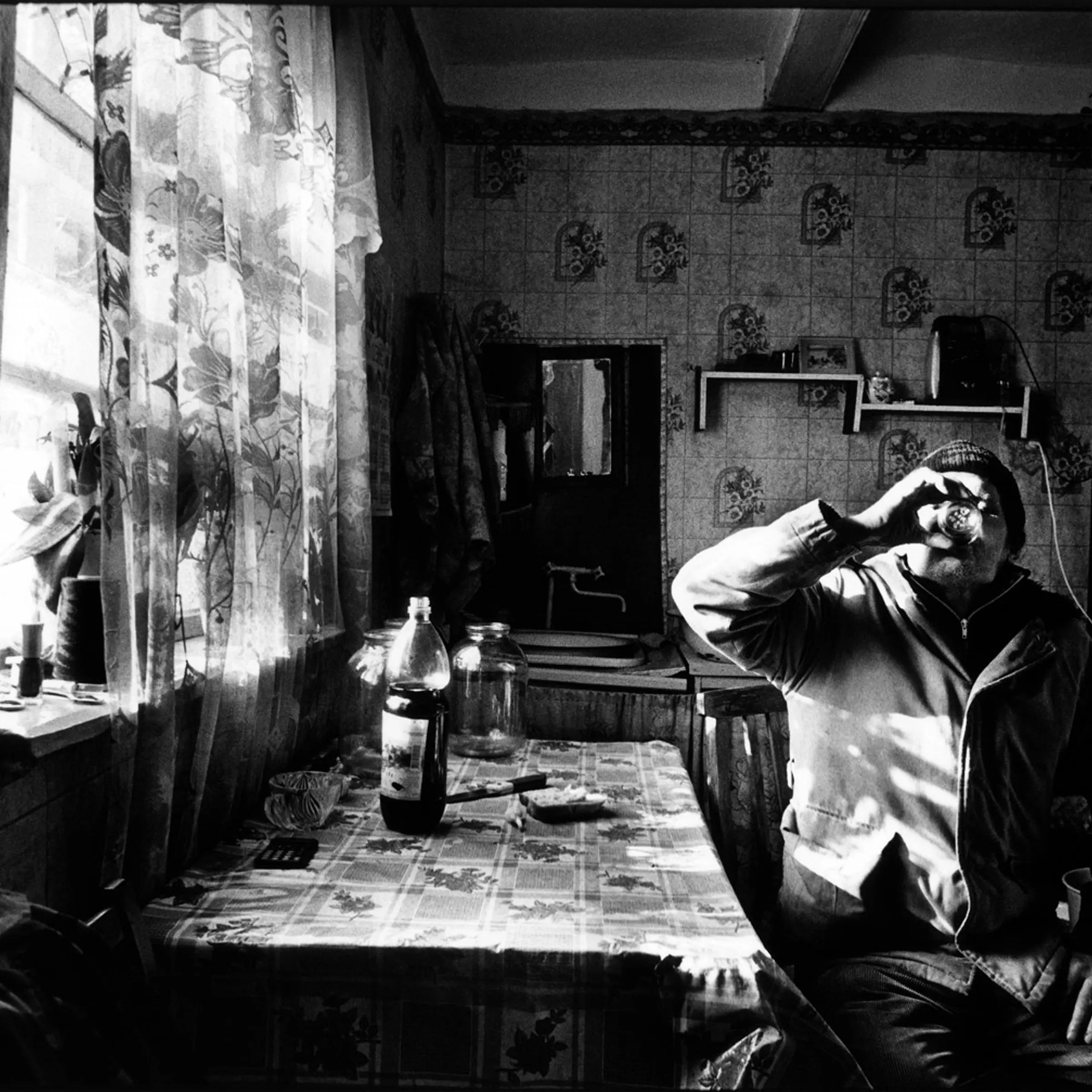 A villager drinks home-made wine.
