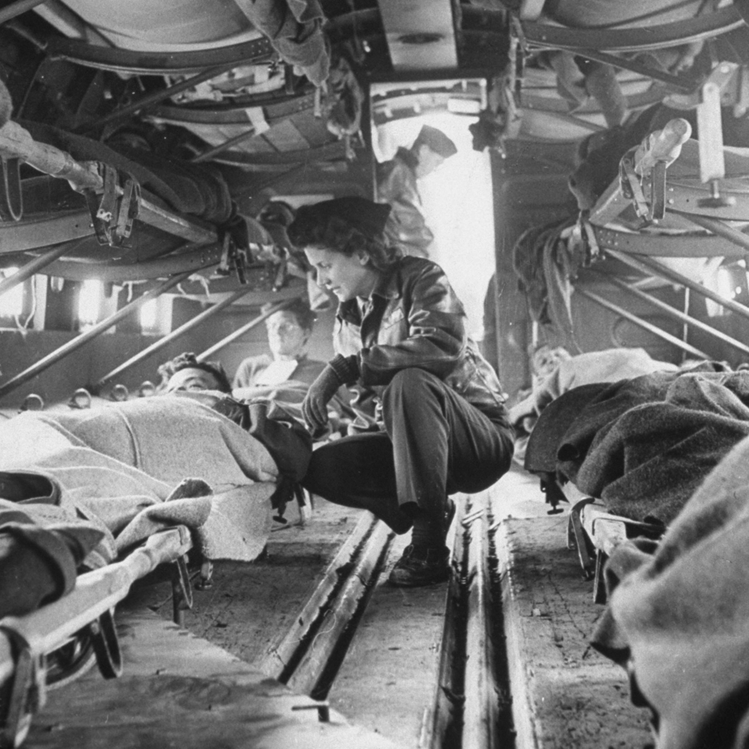 Somewhere over North Africa an American "flying nurse," Second Lieut. Julia Corinne Riley, 23, checks on patients aboard a specially outfitted C-47 transport plane, used to ferry wounded men from the battlefields to hospitals in the rear, spring 1943.