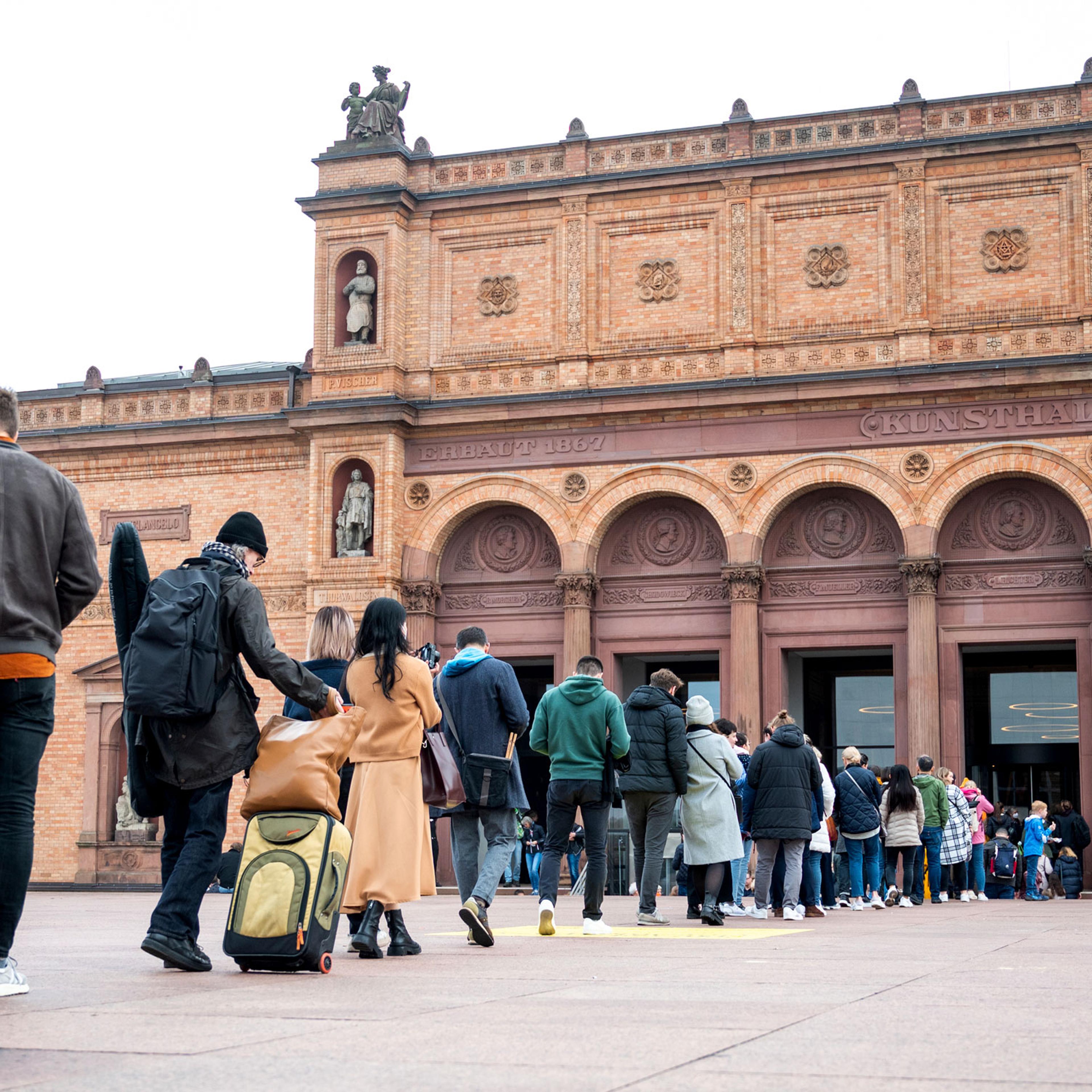 Visitors stand in line in front of the Kunsthalle, in Hamburg, Germany, on Oct. 31, 2022.