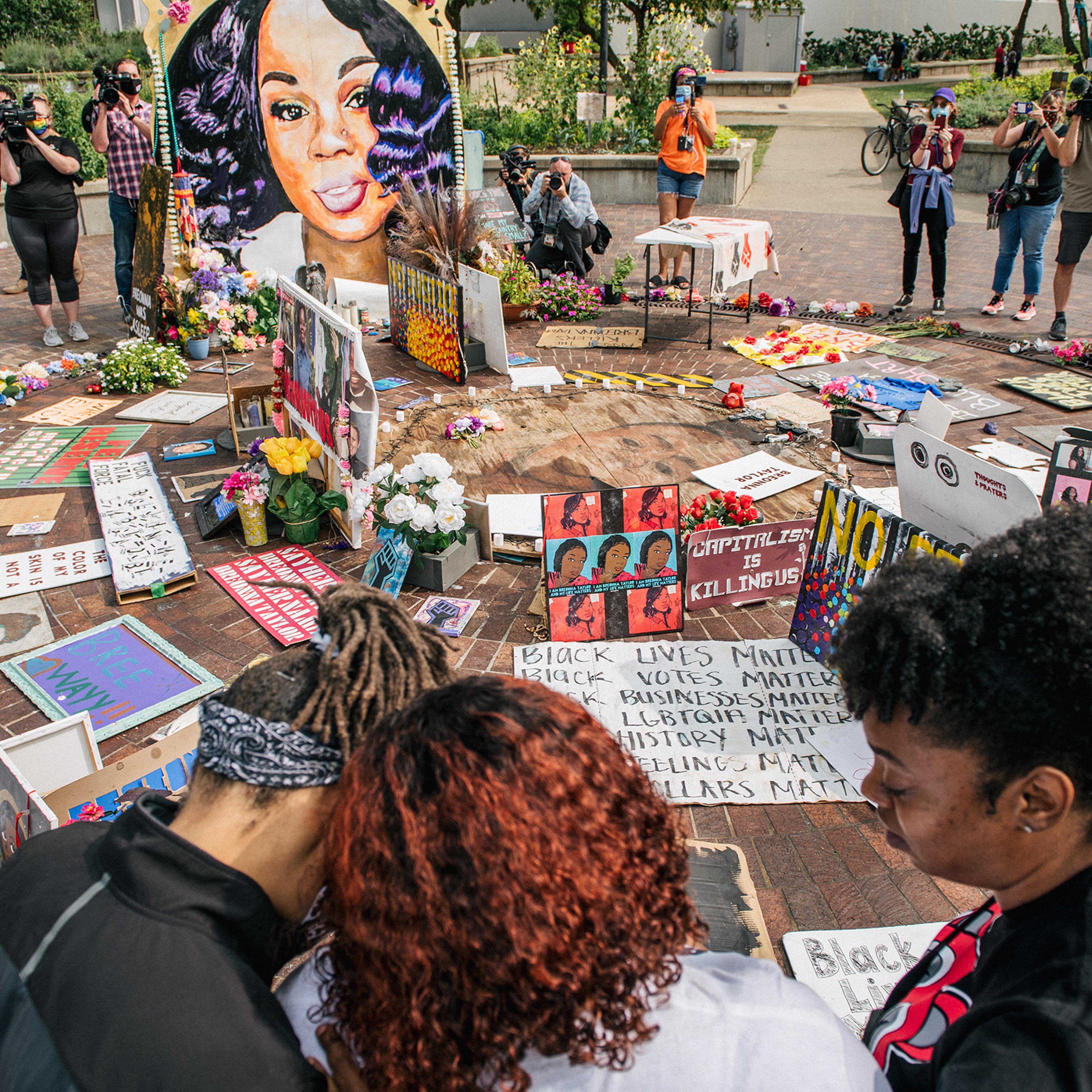 Tamika Palmer, mother of Breonna Taylor, center, is comforted as she looks over a memorial dedicated to her daughter on September 15, 2020 in Louisville, Kentucky.