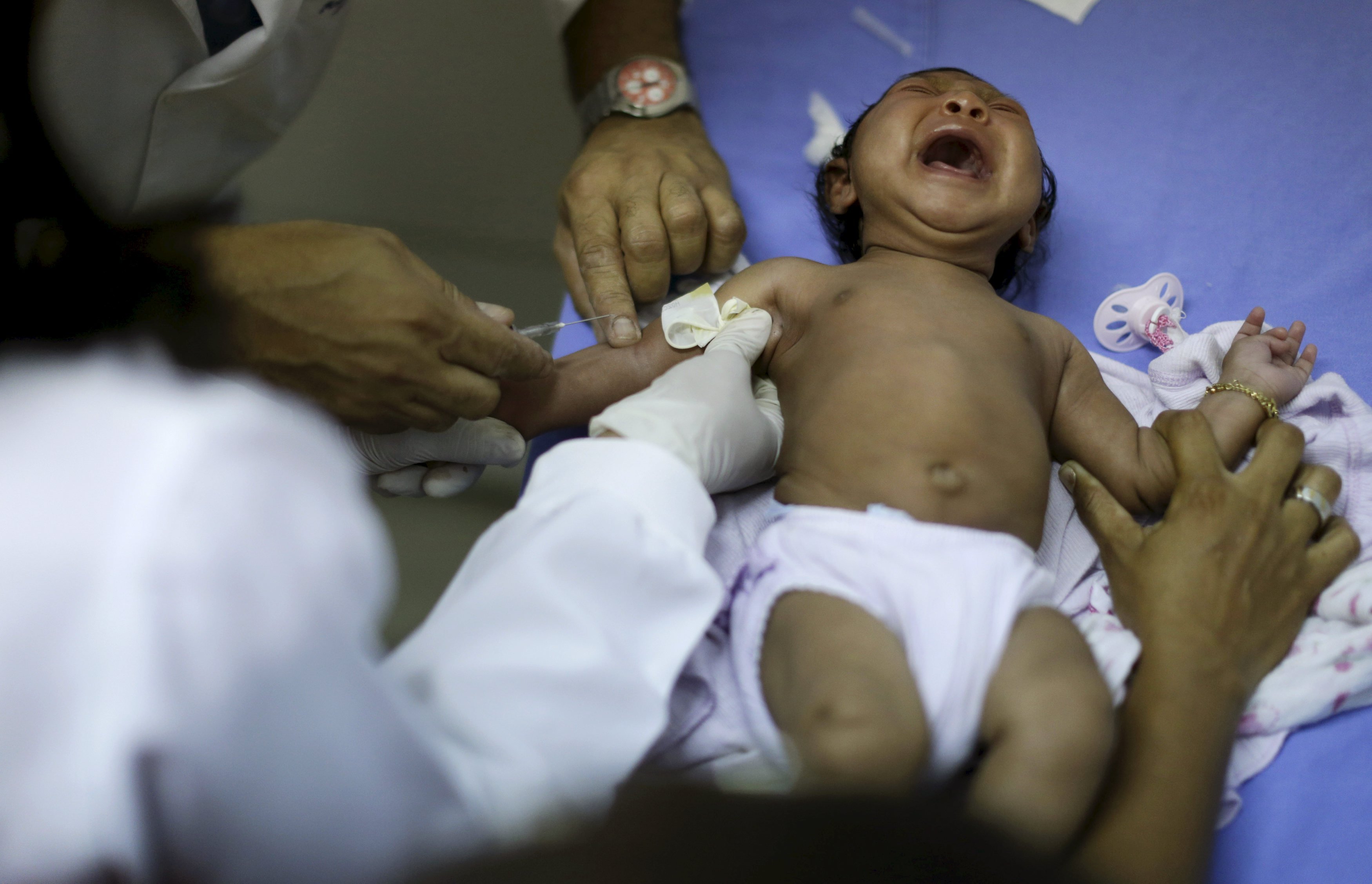 Staff prepare to draw blood from Ludmilla Hadassah Dias de Vasconcelos, who has microcephaly, at the Oswaldo Cruz Hospital in Recife, Brazil, Jan. 26, 2016.