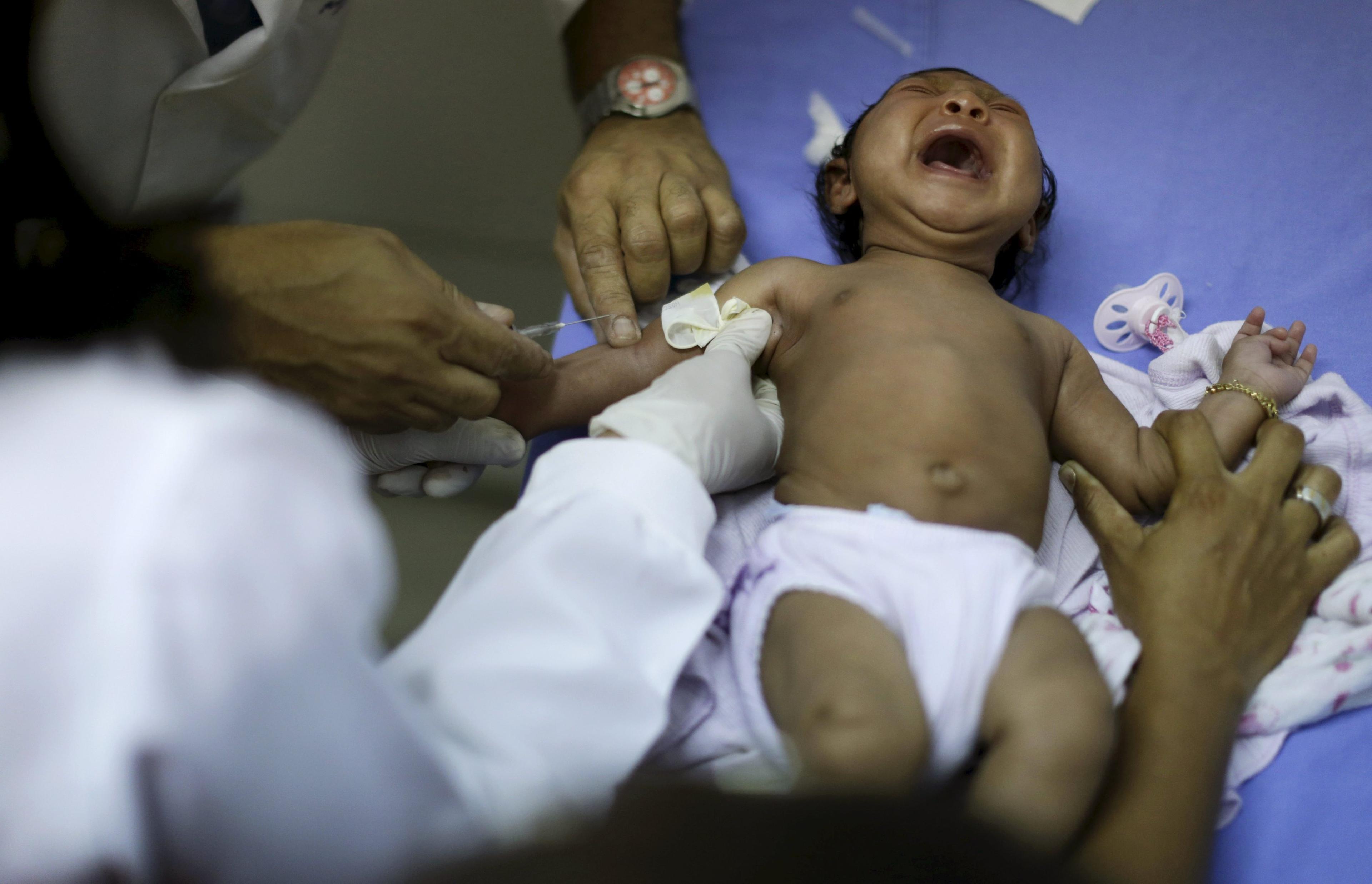 Staff prepare to draw blood from Ludmilla Hadassah Dias de Vasconcelos, who has microcephaly, at the Oswaldo Cruz Hospital in Recife, Brazil, Jan. 26, 2016.