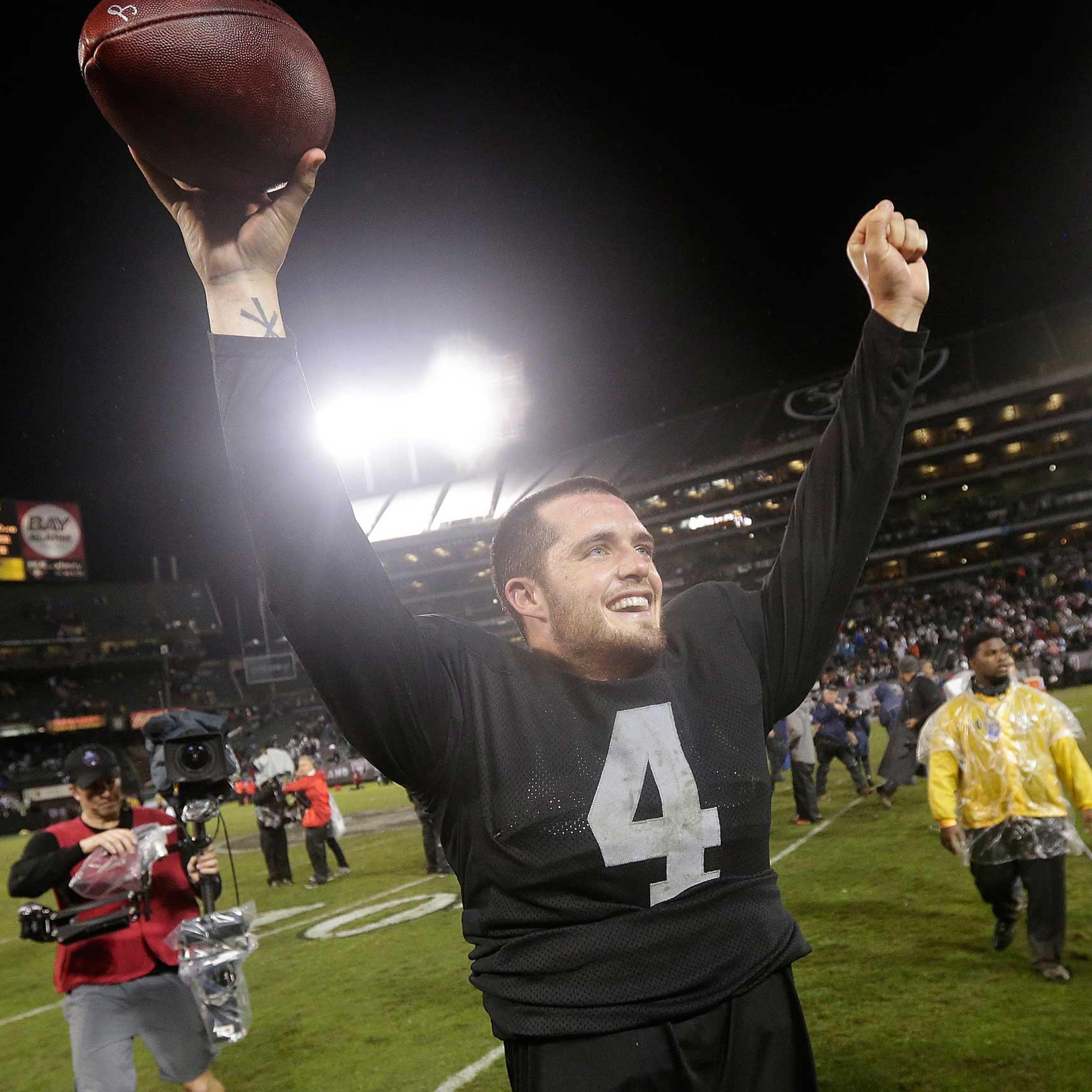 Oakland Raiders quarterback Derek Carr celebrates after the Raiders defeated the Kansas City Chiefs 24-20 in an NFL football game in Oakland, Calif., Nov. 20, 2014.