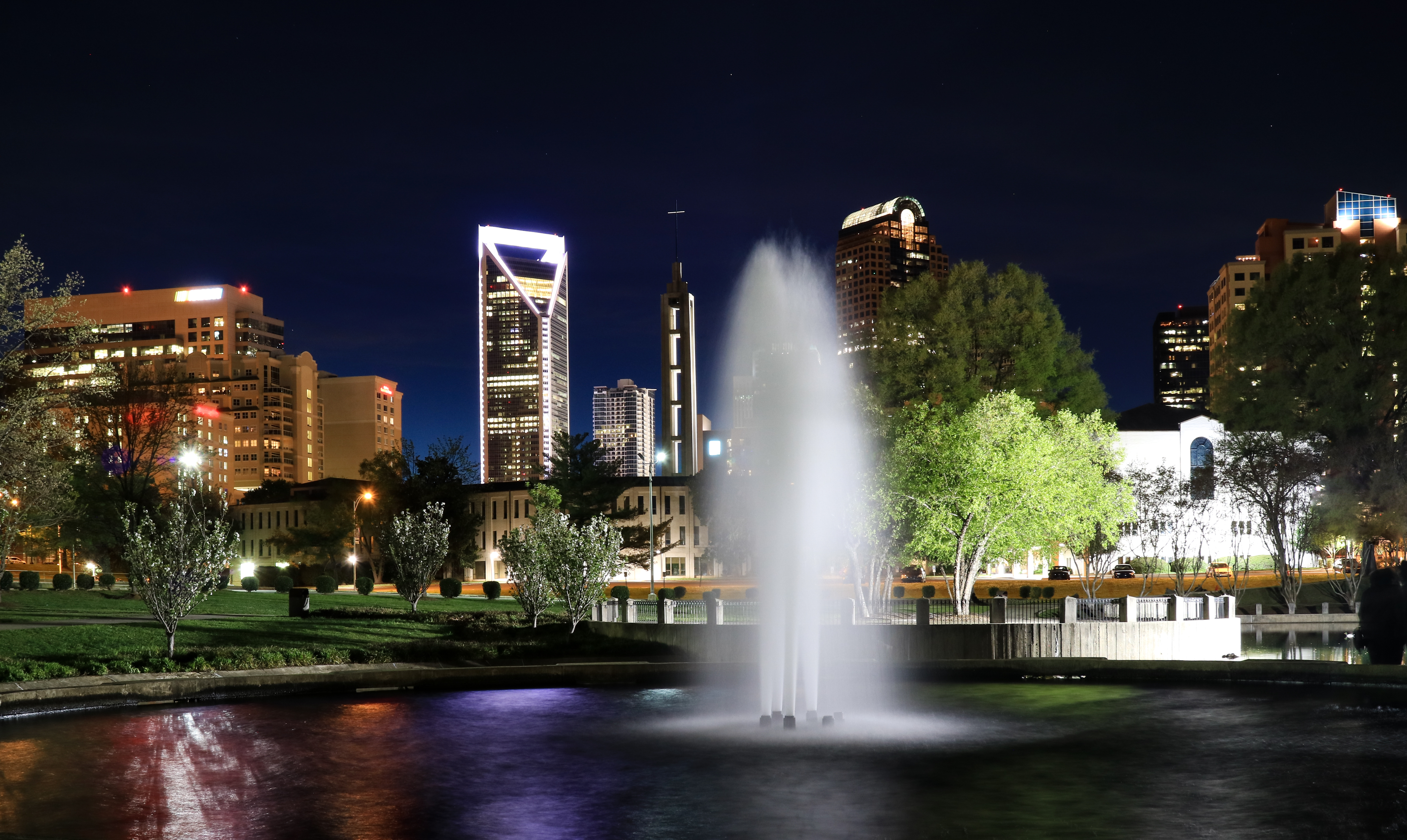 Fountain at Marshall Park with the Charlotte North Carolina skyline beyond.