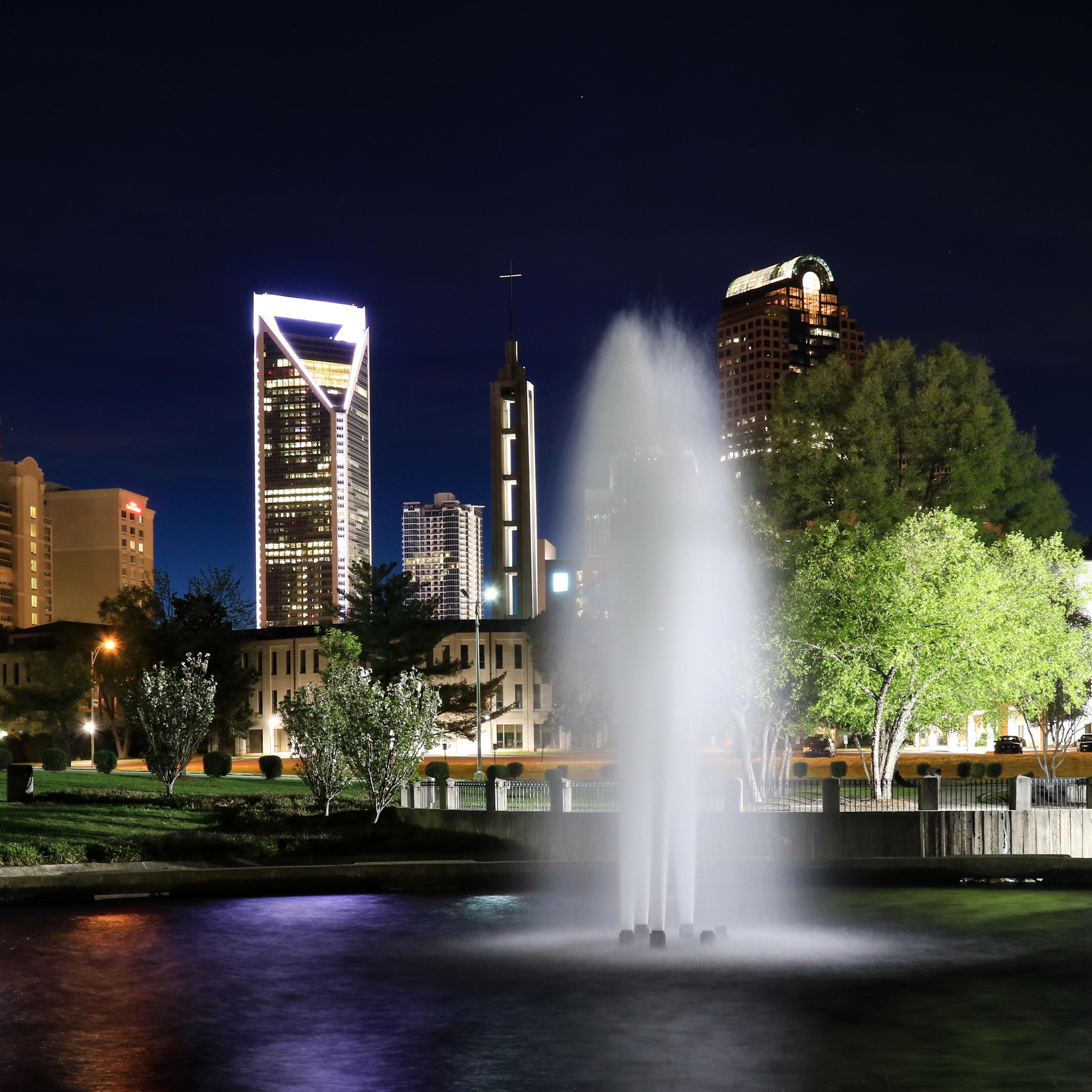 Fountain at Marshall Park with the Charlotte North Carolina skyline beyond.