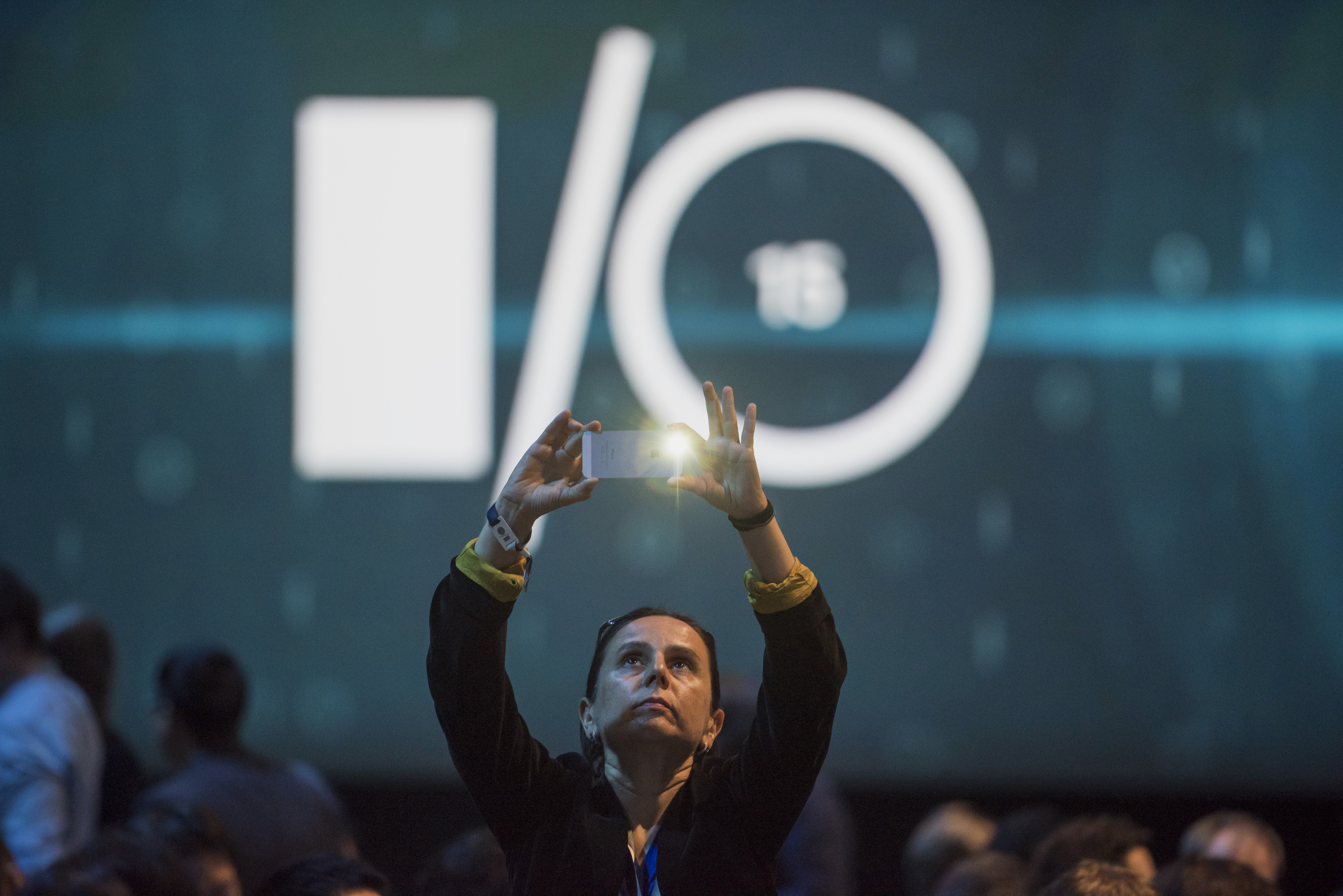 An attendee takes a photograph prior to the Google I/O Annual Developers Conference in San Francisco, California, U.S., on Thursday, May 28, 2014. Google Inc. executives are taking the stage this week to talk about a plethora of new technologies, includi