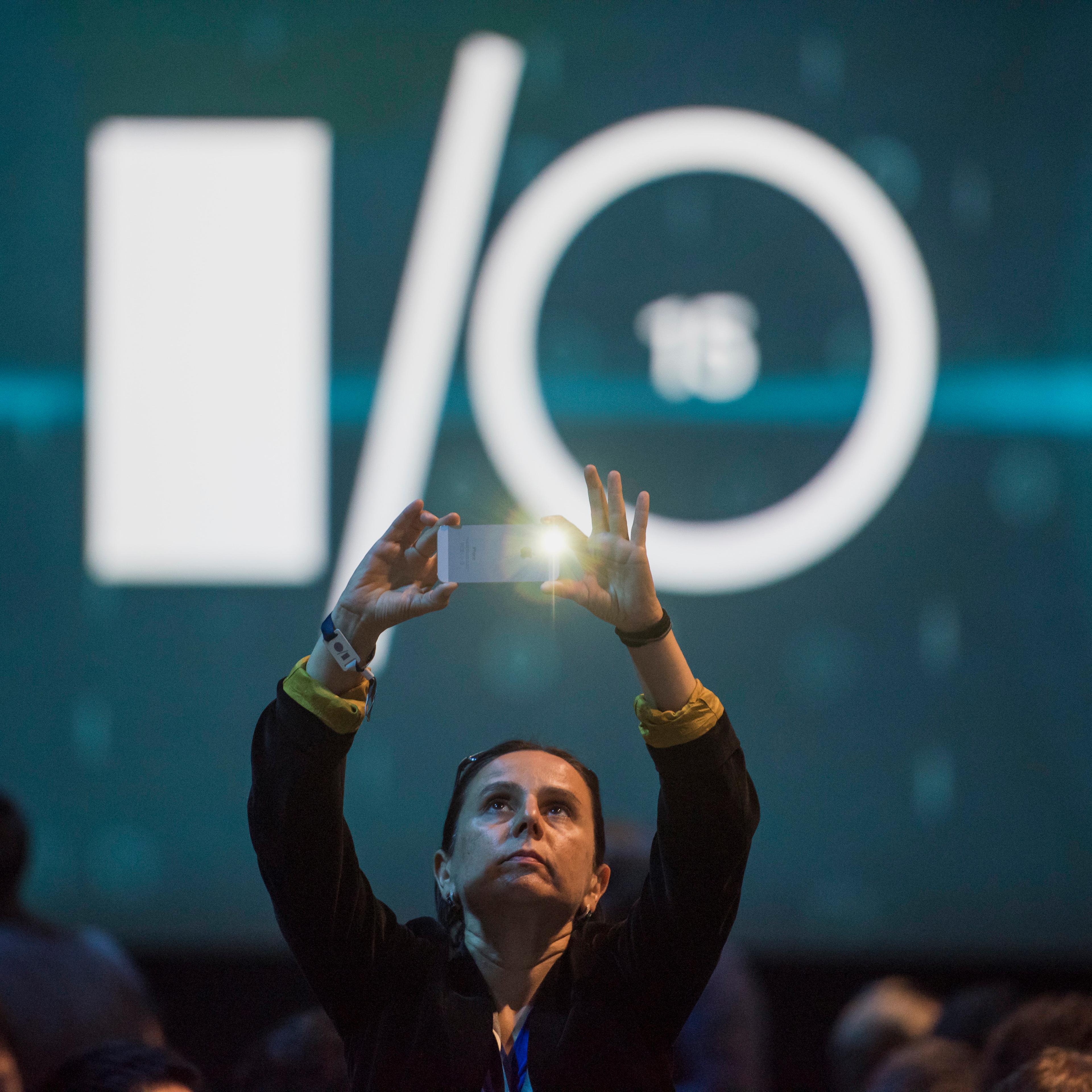 An attendee takes a photograph prior to the Google I/O Annual Developers Conference in San Francisco, California, U.S., on Thursday, May 28, 2014. Google Inc. executives are taking the stage this week to talk about a plethora of new technologies, includi