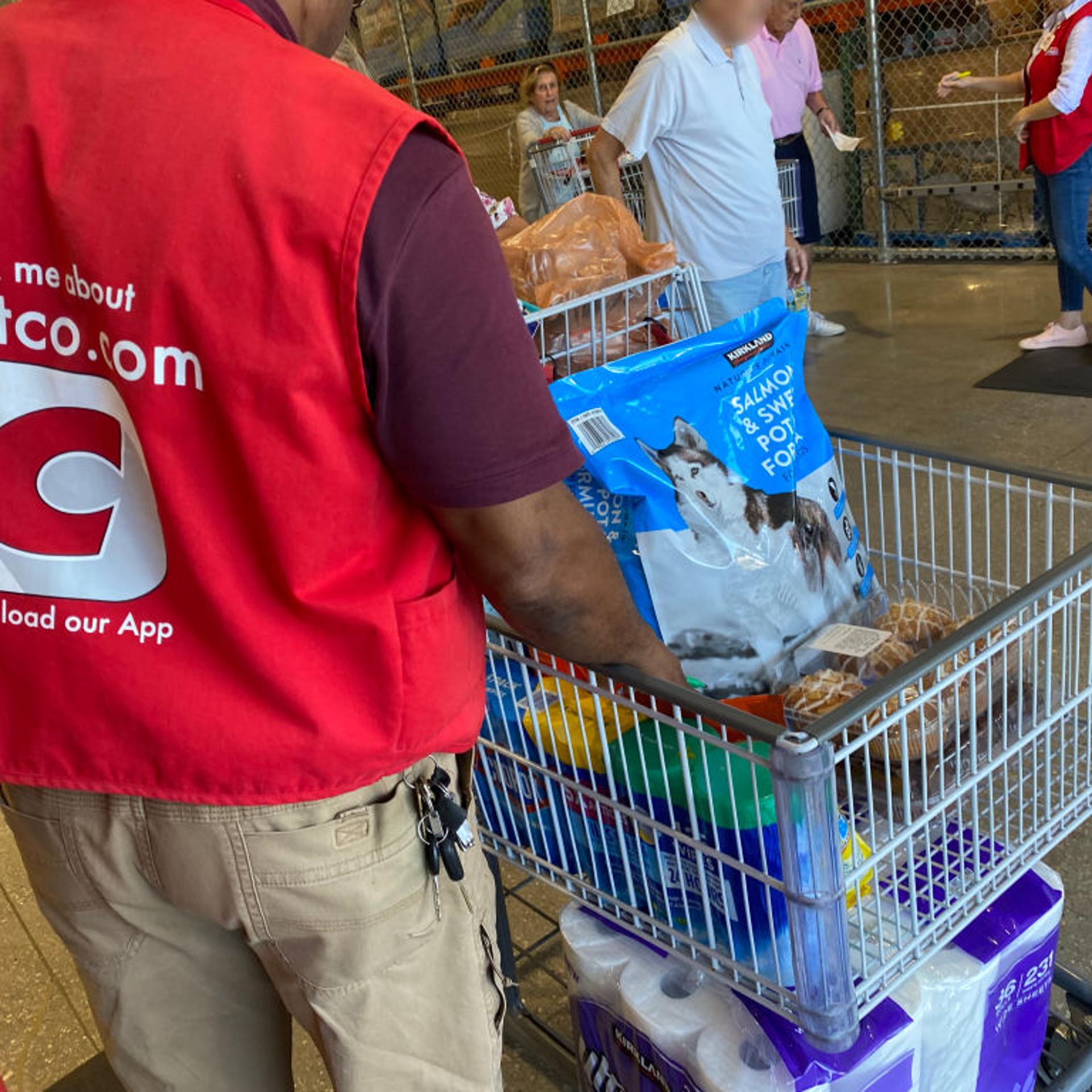 Costco employee reviewing customers shopping cart against receipt, Costco, Palm Beach, Florida