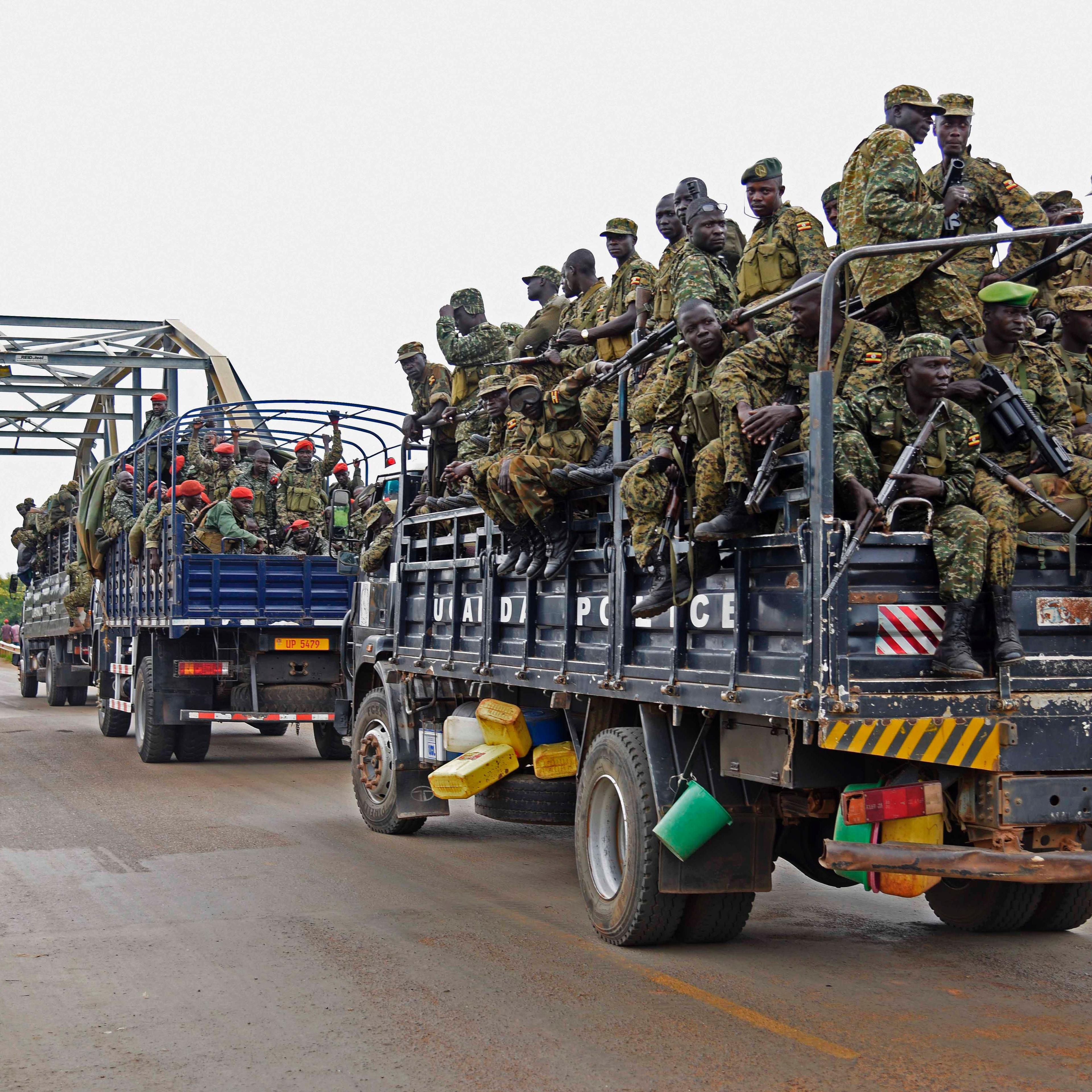 Uganda military personnel are seen atop military and police trucks as they drive towards Juba in South Sudan at Nimule border point on July 14, 2016.