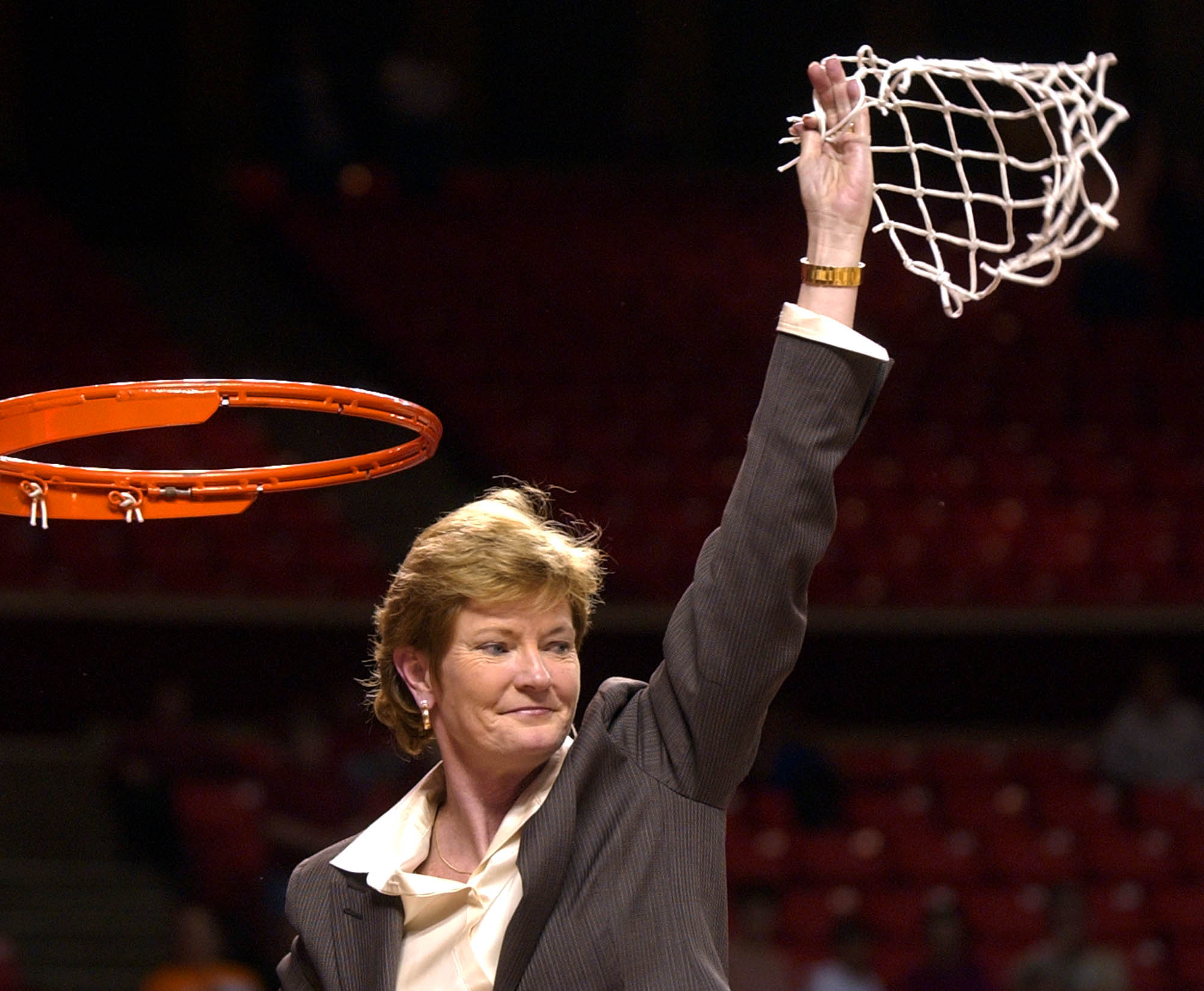 Tennessee coach Pat Summitt waves the net after her team beat Stanford 62-60 at the NCAA Midwest Regional final in Norman, Okla., on March 30, 2004.
