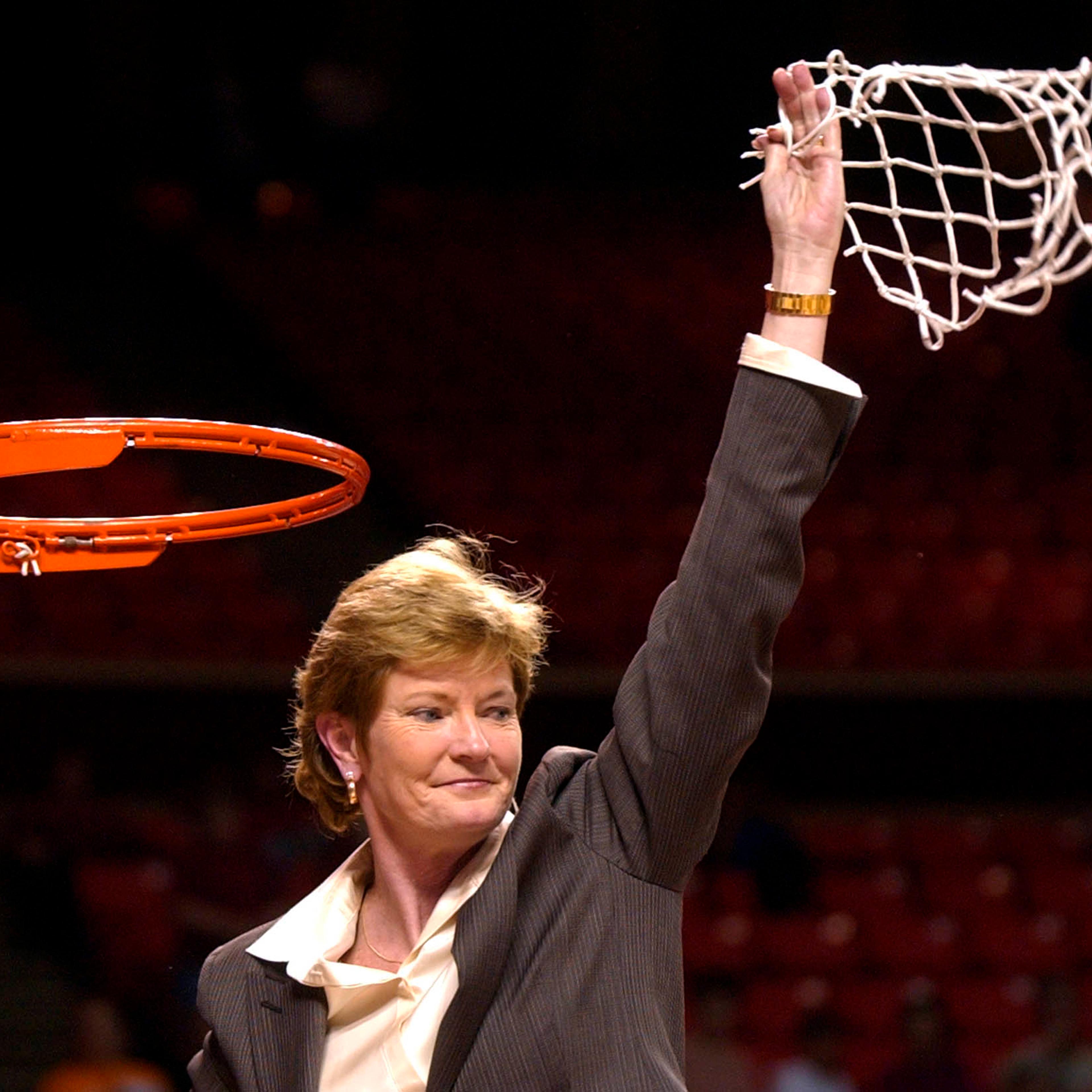 Tennessee coach Pat Summitt waves the net after her team beat Stanford 62-60 at the NCAA Midwest Regional final in Norman, Okla., on March 30, 2004.