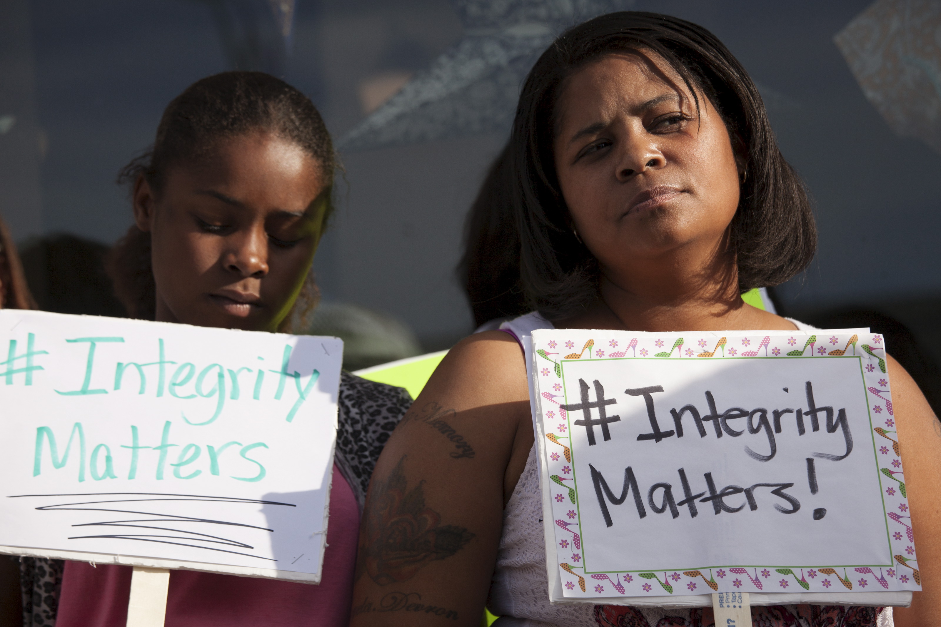 Women hold signs during a protest in front of the National Association for the Advancement of Colored People (NAACP) headquarters in Spokane, Washington