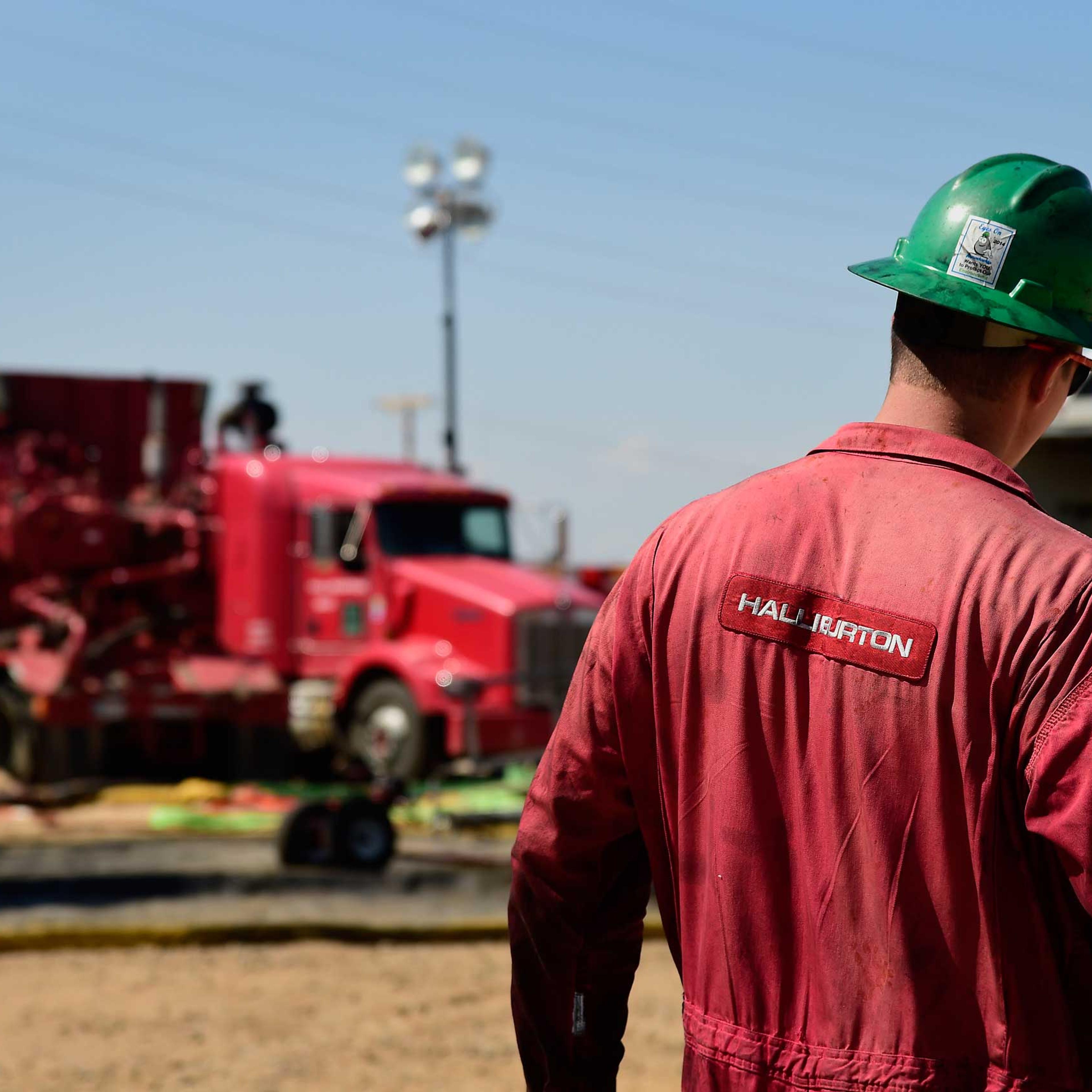 A Halliburton Co. worker walks through an Anadarko Petroleum Corp. hydraulic fracturing (fracking) site north of Dacono, Colo. on Aug. 12, 2014.