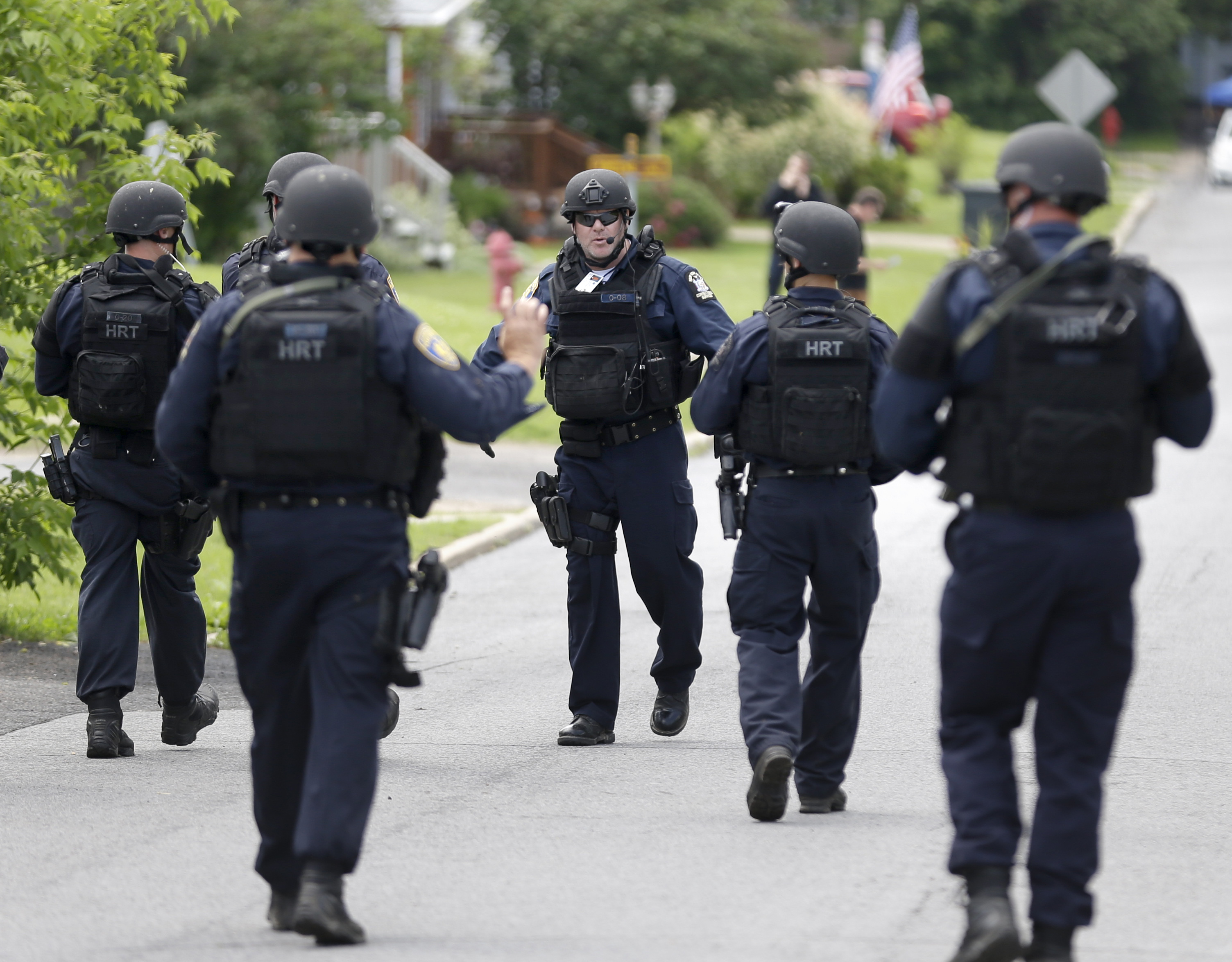 Law enforcement officials walk the streets near the prison in Dannemora, N.Y., on June 10, 2015.