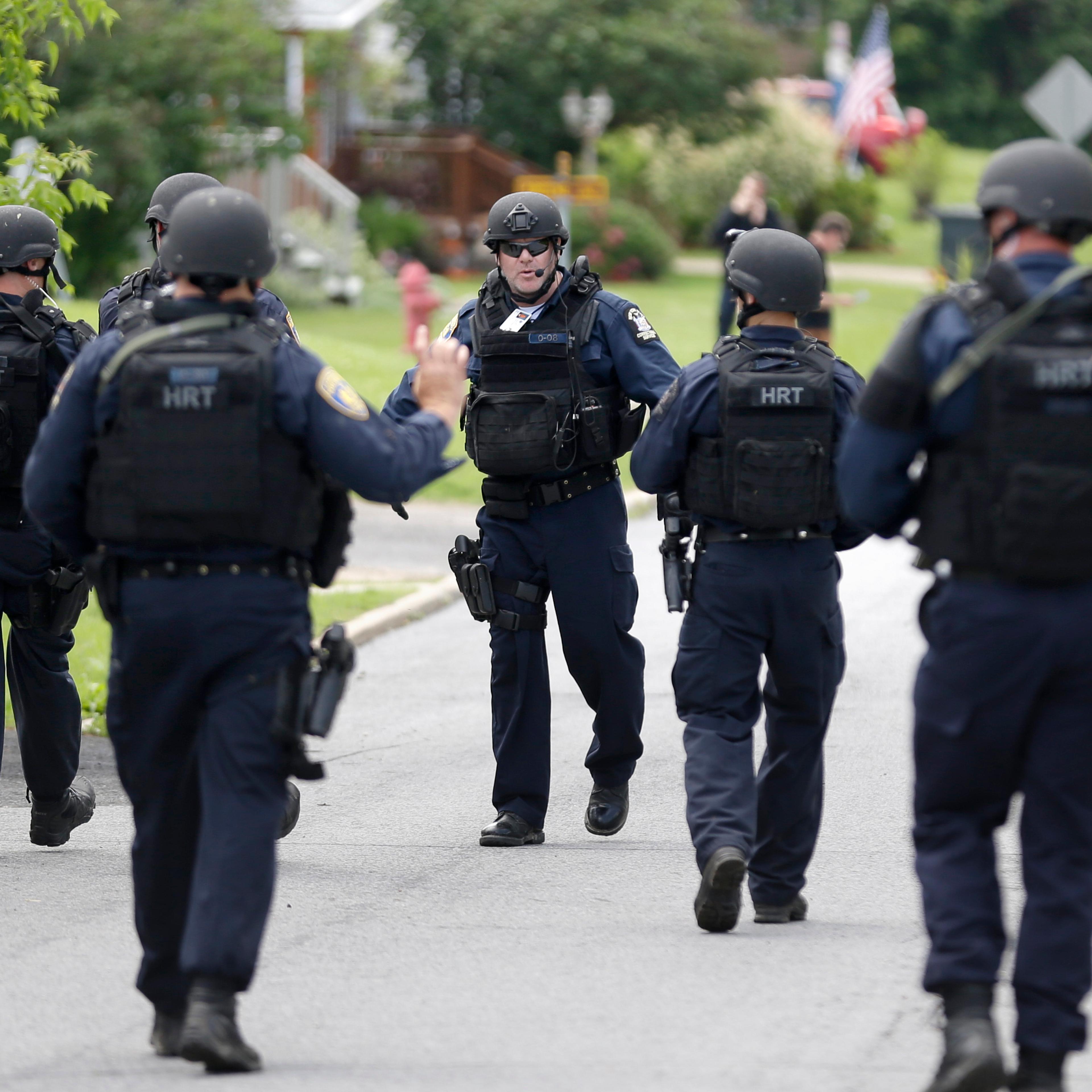 Law enforcement officials walk the streets near the prison in Dannemora, N.Y., on June 10, 2015.