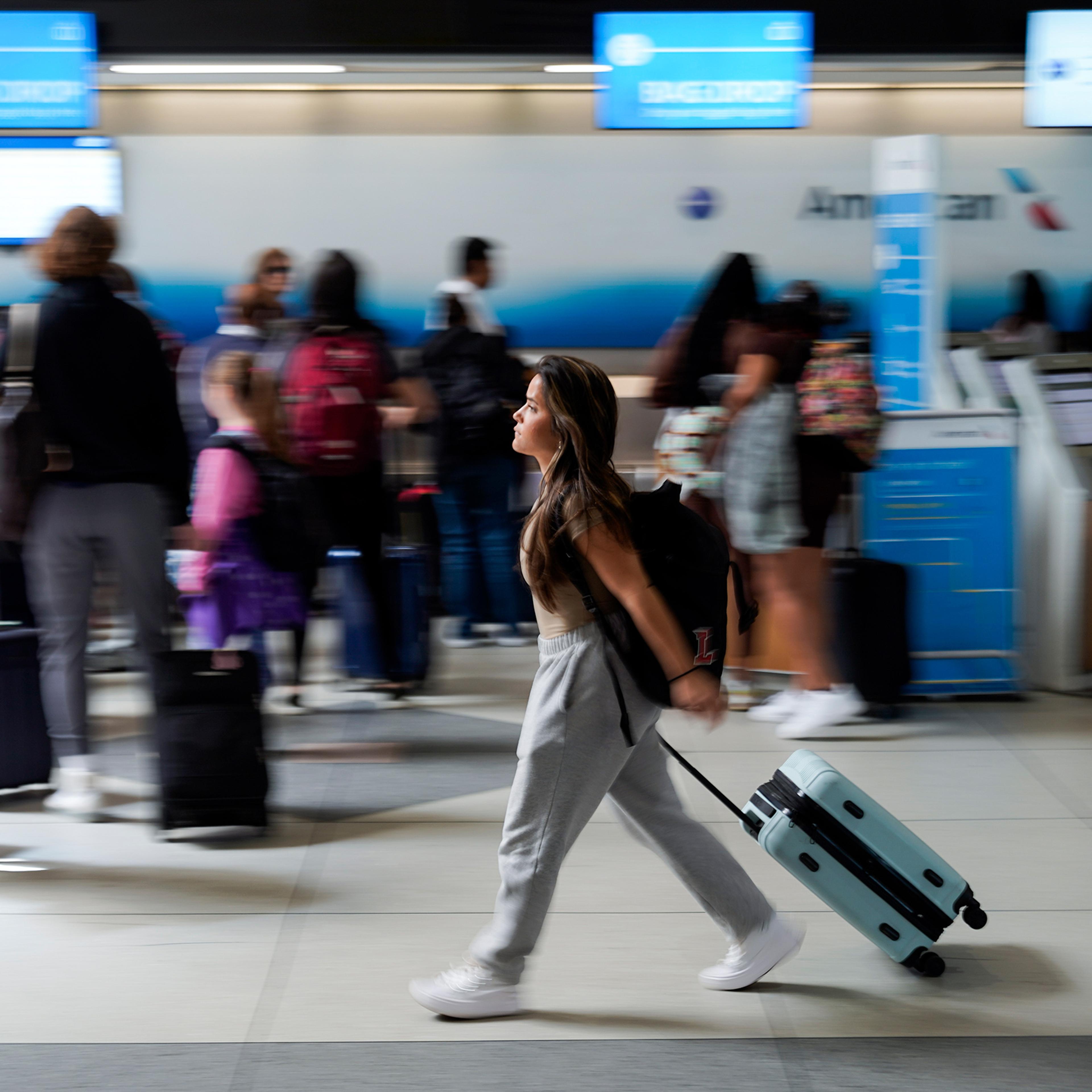 A person walks by the ticketing lobby at the Charlotte Douglas International Airport on May 25, 2023, in Charlotte, N.C.