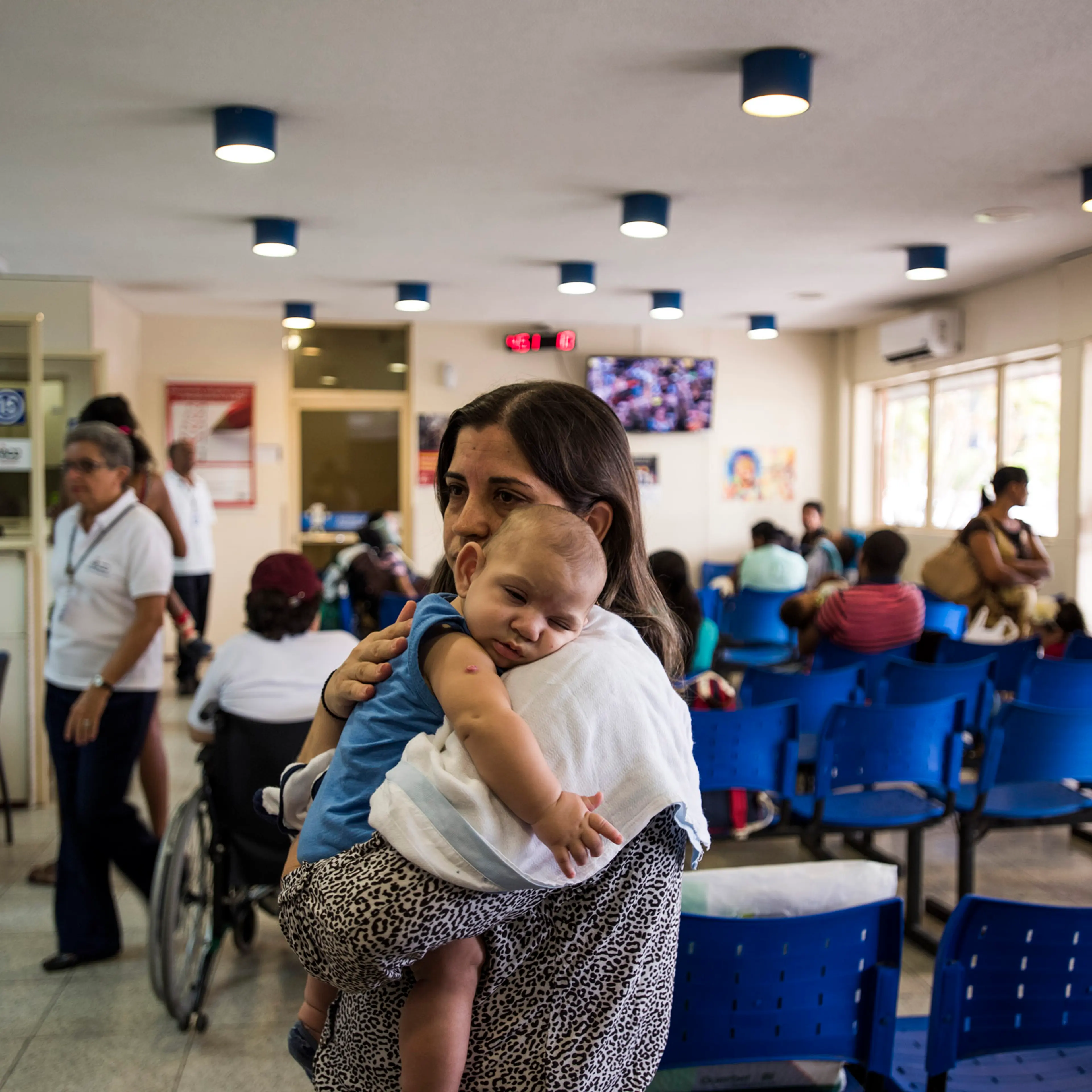 Isabel Albuquerque and her son in the waiting room of Associacao de Assistencia a Crianca Deficiente, a rehabilitation center for disabled children, in Recife, Brazil, Feb. 1, 2016.