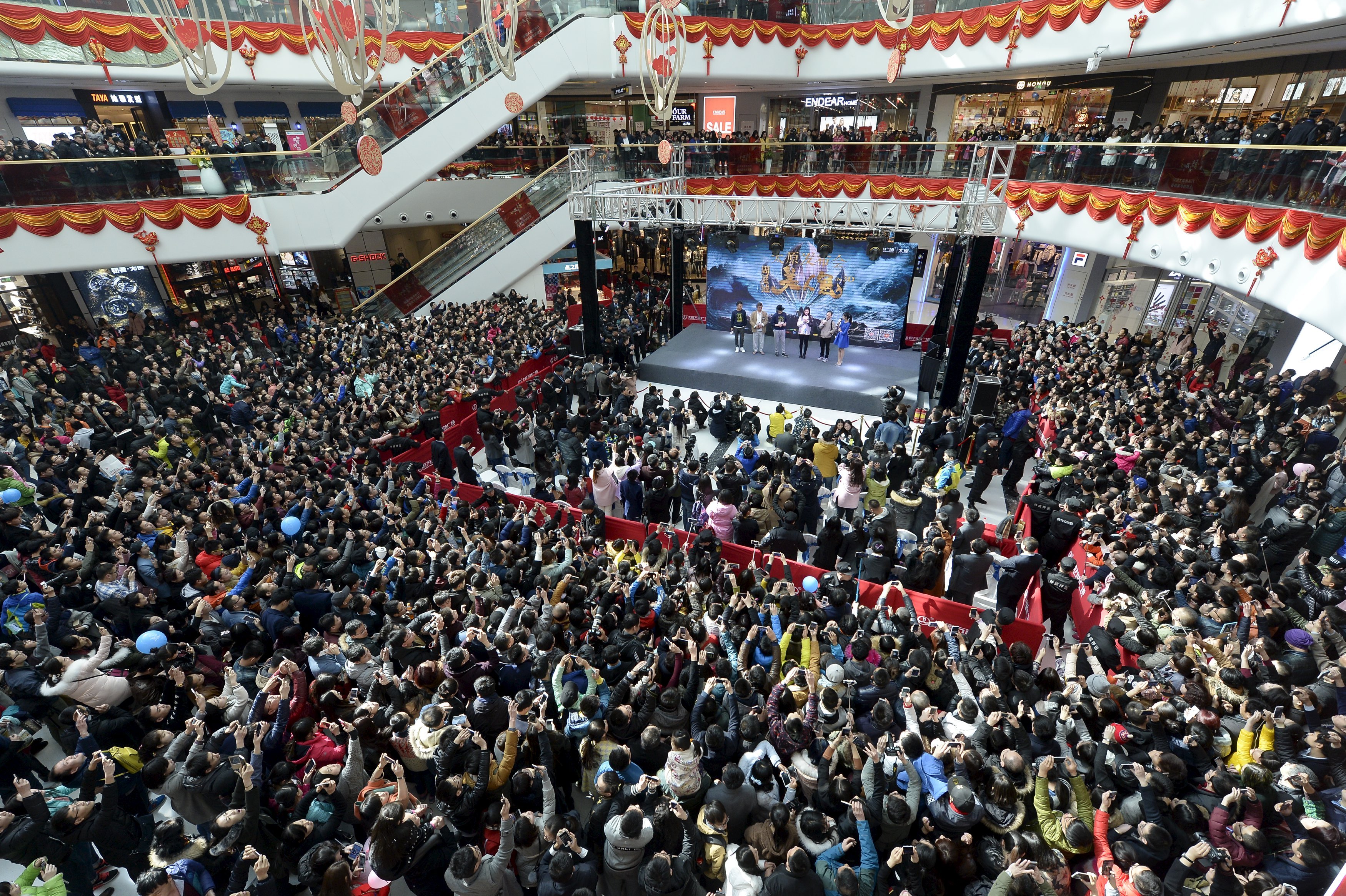 People attend a promotional event with Hong Kong star Stephen Chow for the film, The Mermaid, in Taiyuan