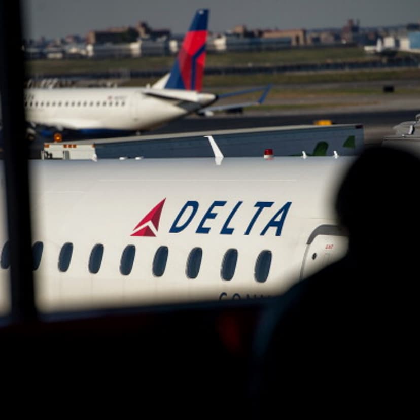 The silhouette of a passenger waiting for a flight is seen in the Delta Air Lines Inc. terminal at LaGuardia Airport in New York on Oct. 21, 2013.