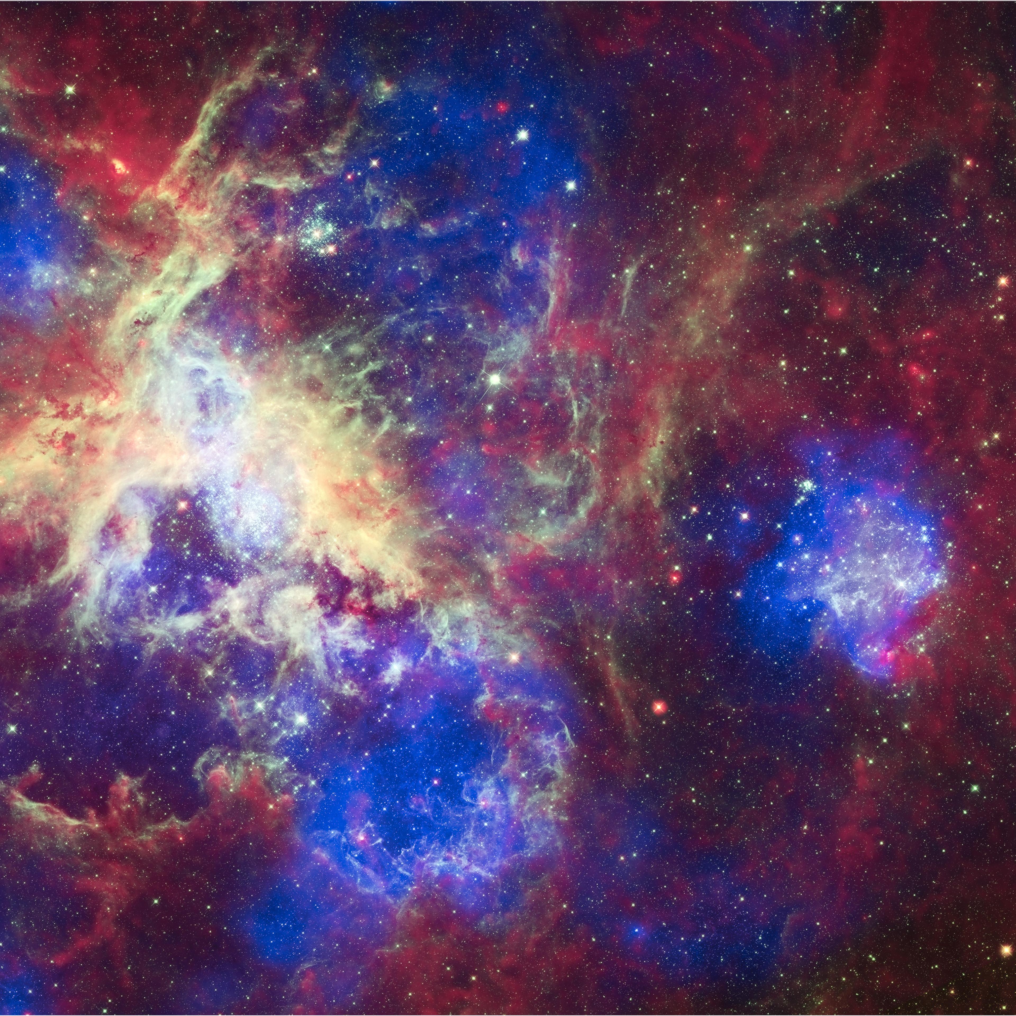 This composite of 30 photos of theTarantula Nebula, contains data from Chandra (blue), Hubble (green), and Spitzer (red). Located in the Large Magellanic Cloud, the Tarantula Nebula is one of the largest star-forming regions close to the Milky Way.