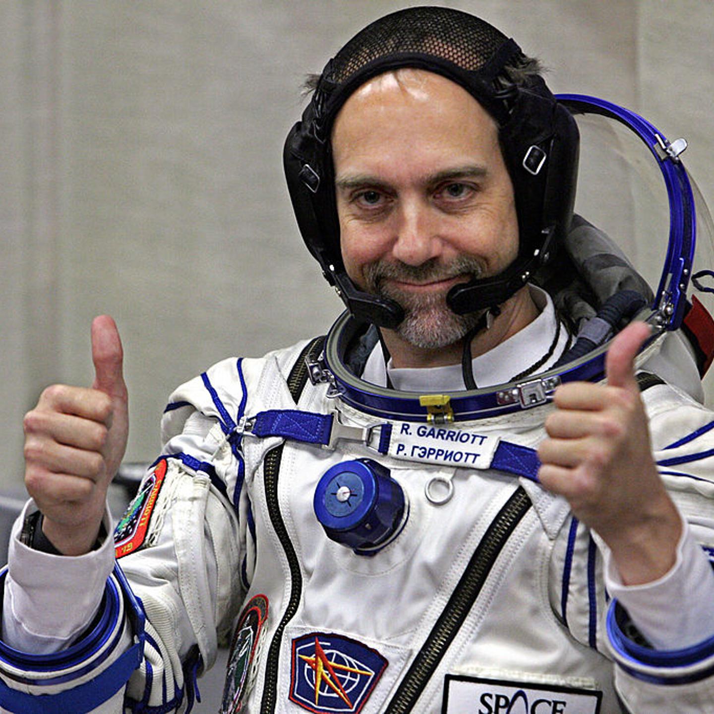 U.S. space tourist Richard Garriott gestures after putting on a space suit at the Baikonur cosmodrome, in Kazakhstan, on Oct. 12, 2008.