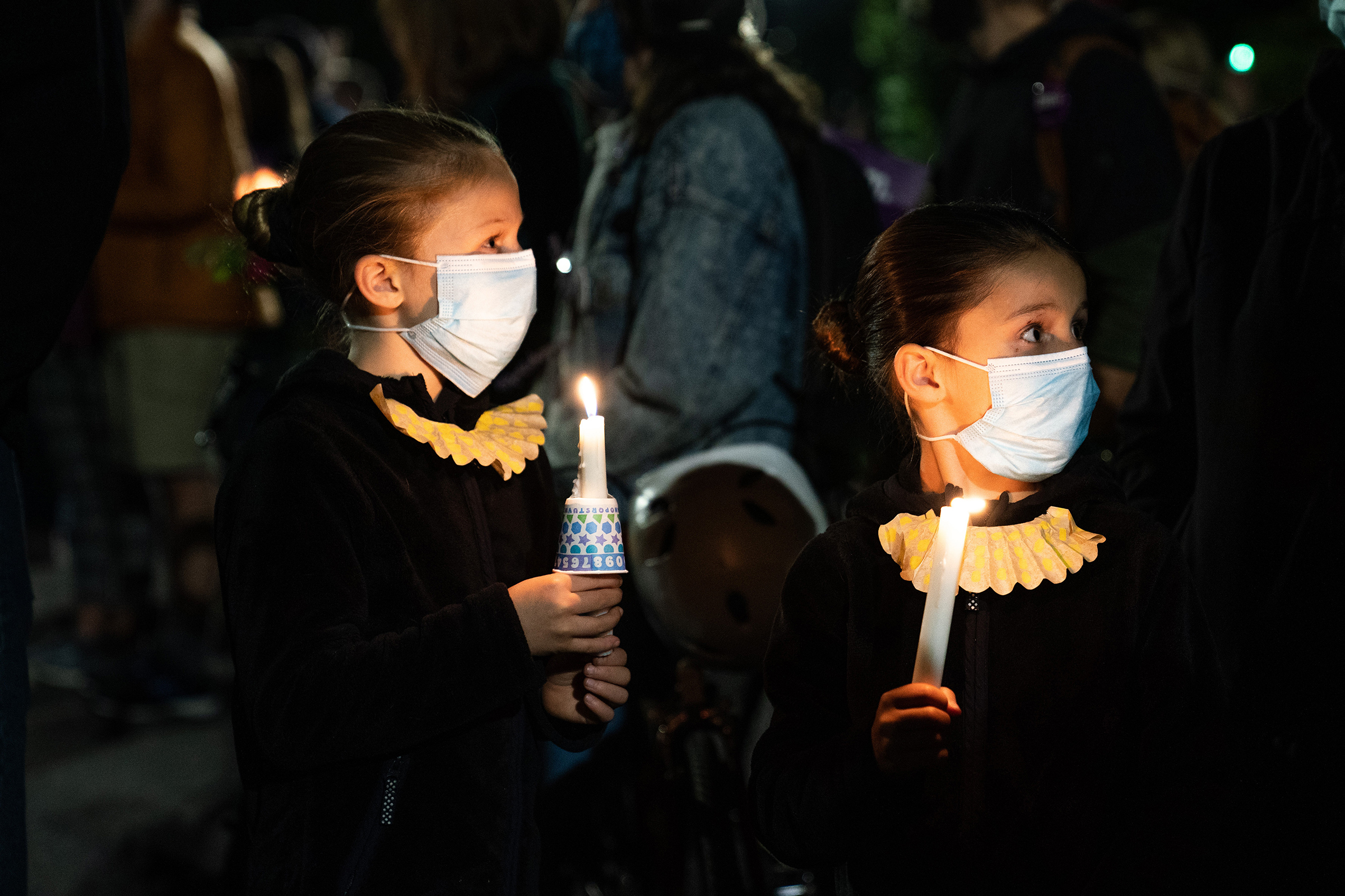 Girls dressed as Justice Ruth Bader Ginsburg stand with mourners outside the Supreme Court in Washington, D.C., on Sept. 19, a day after Ginsburg's death.