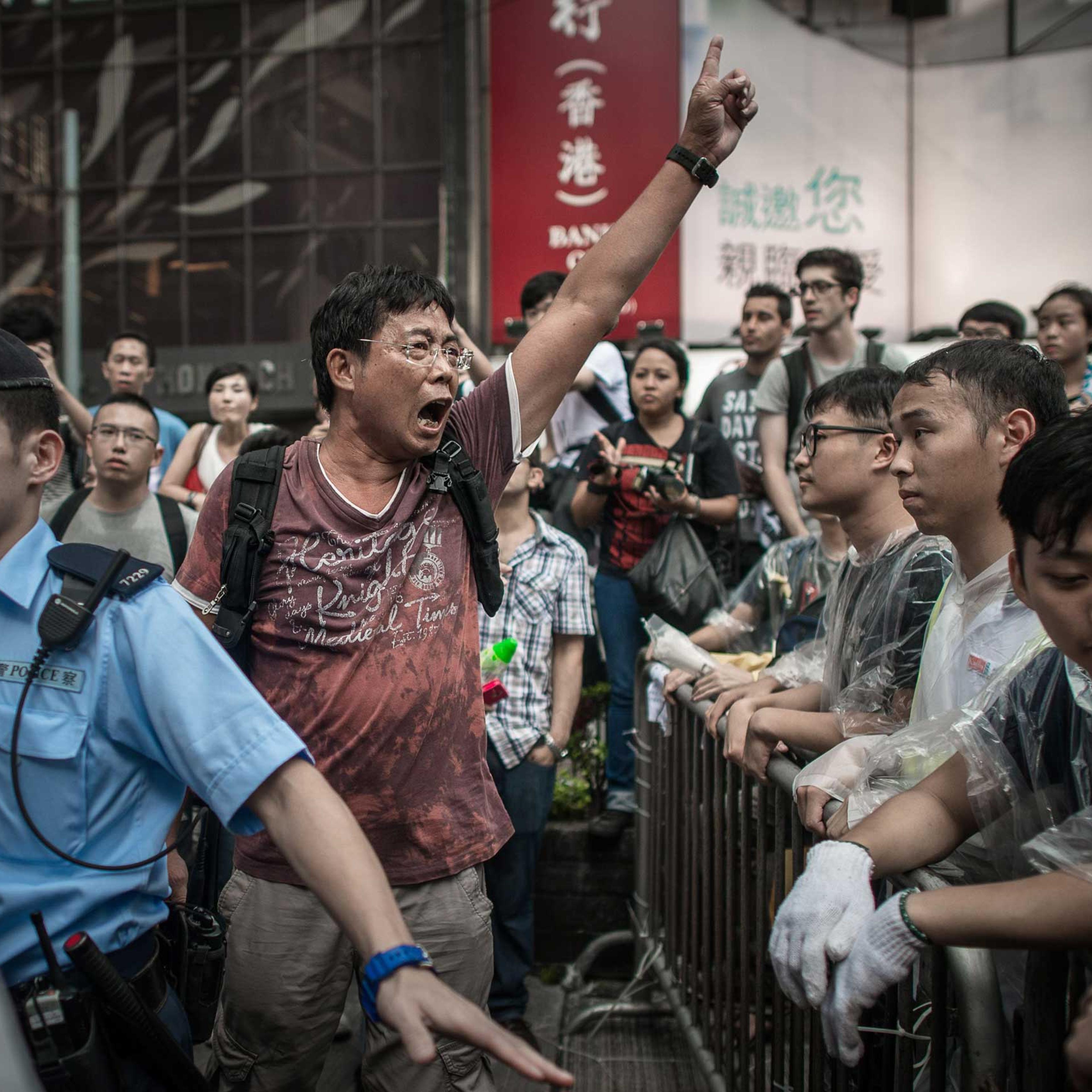 An anti-Occupy protester shouts at pro-democracy demonstrators in an occupied area of Hong Kong on Oct. 3, 2014.