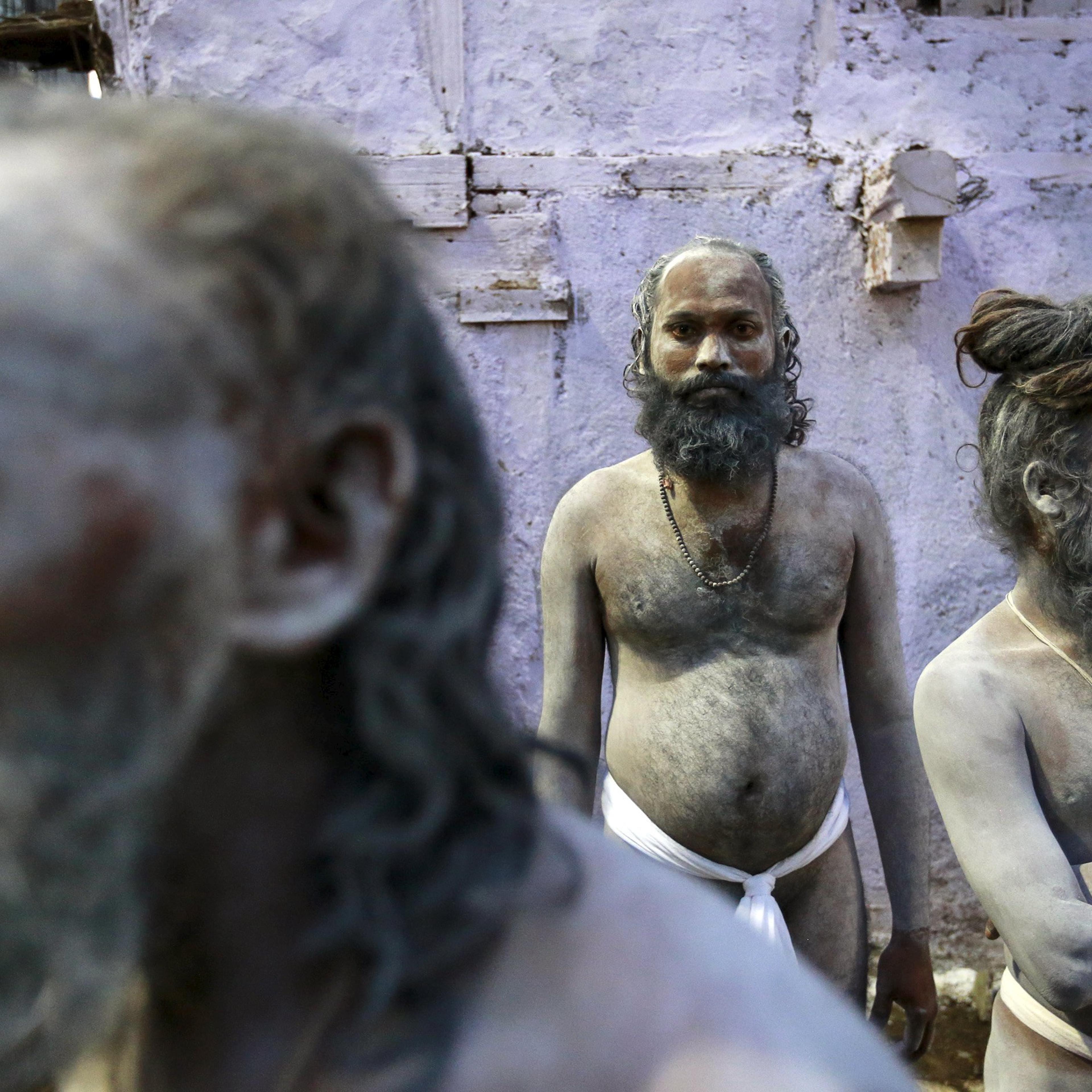 Naga Sadhus, or Hindu holy men, wait during a procession before taking a dip in a holy pond during the second "Shahi Snan" (grand bath) at "Kumbh Mela", or Pitcher Festival, in Trimbakeshwar