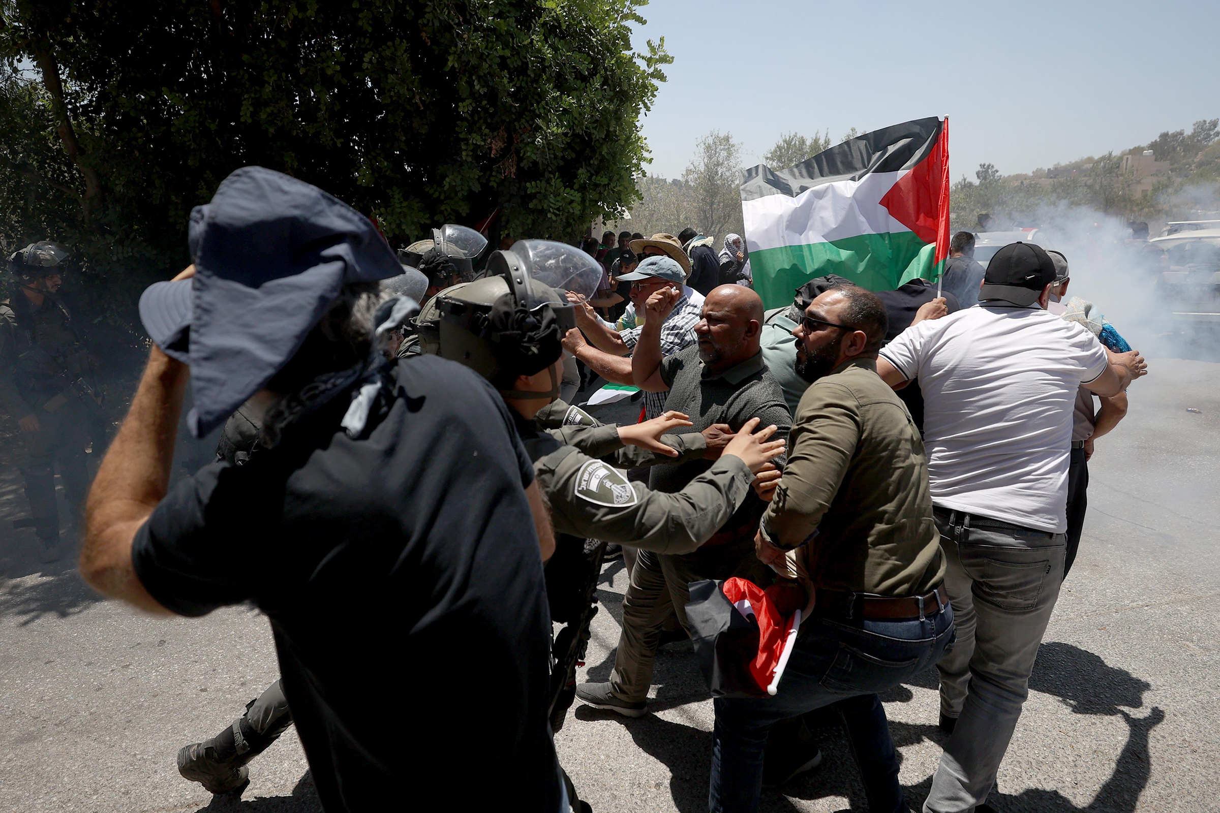 Israeli forces intervene Palestinians during a protest against constructions of Jewish settlements in Ramallah, West Bank, on July 14.
