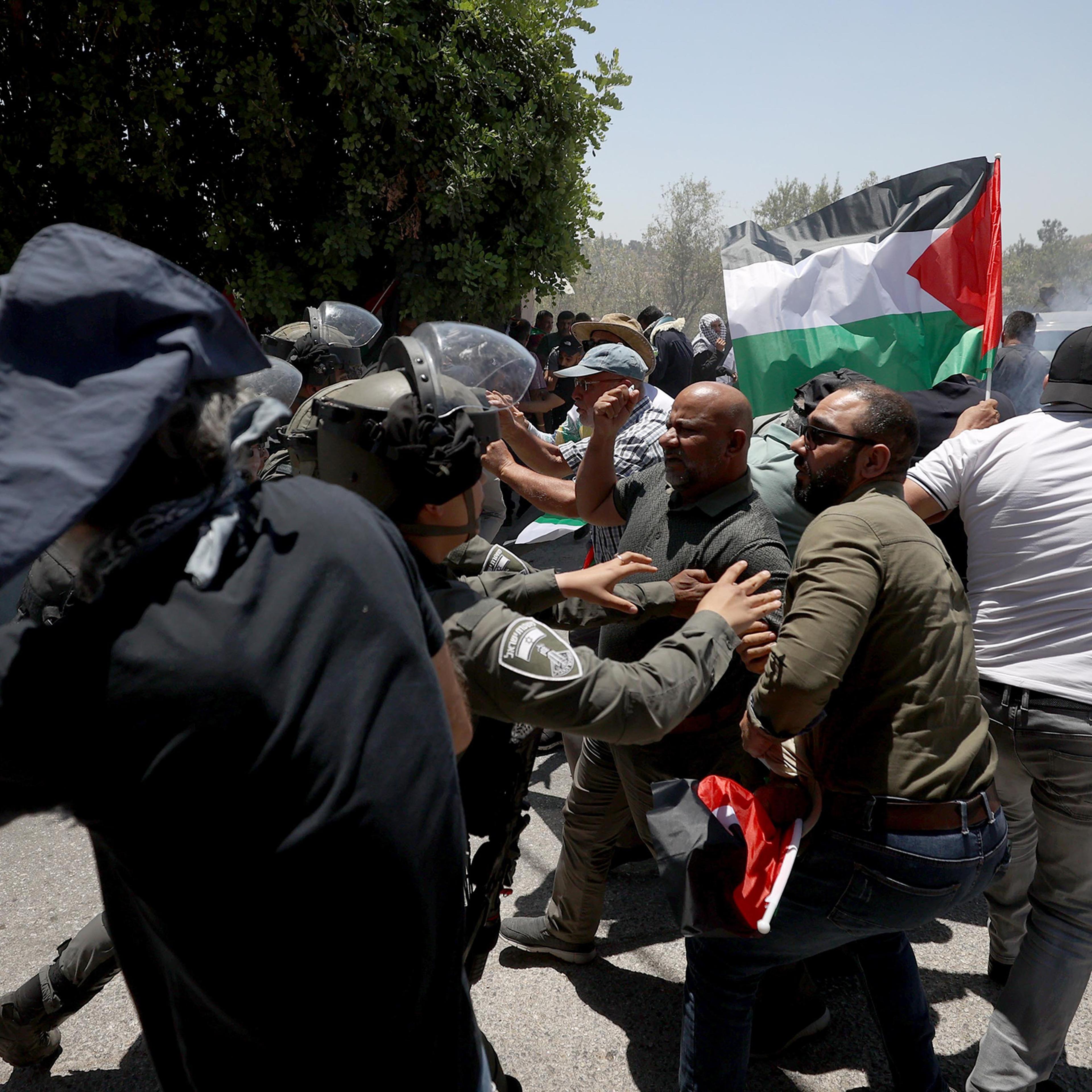 Israeli forces intervene Palestinians during a protest against constructions of Jewish settlements in Ramallah, West Bank, on July 14.