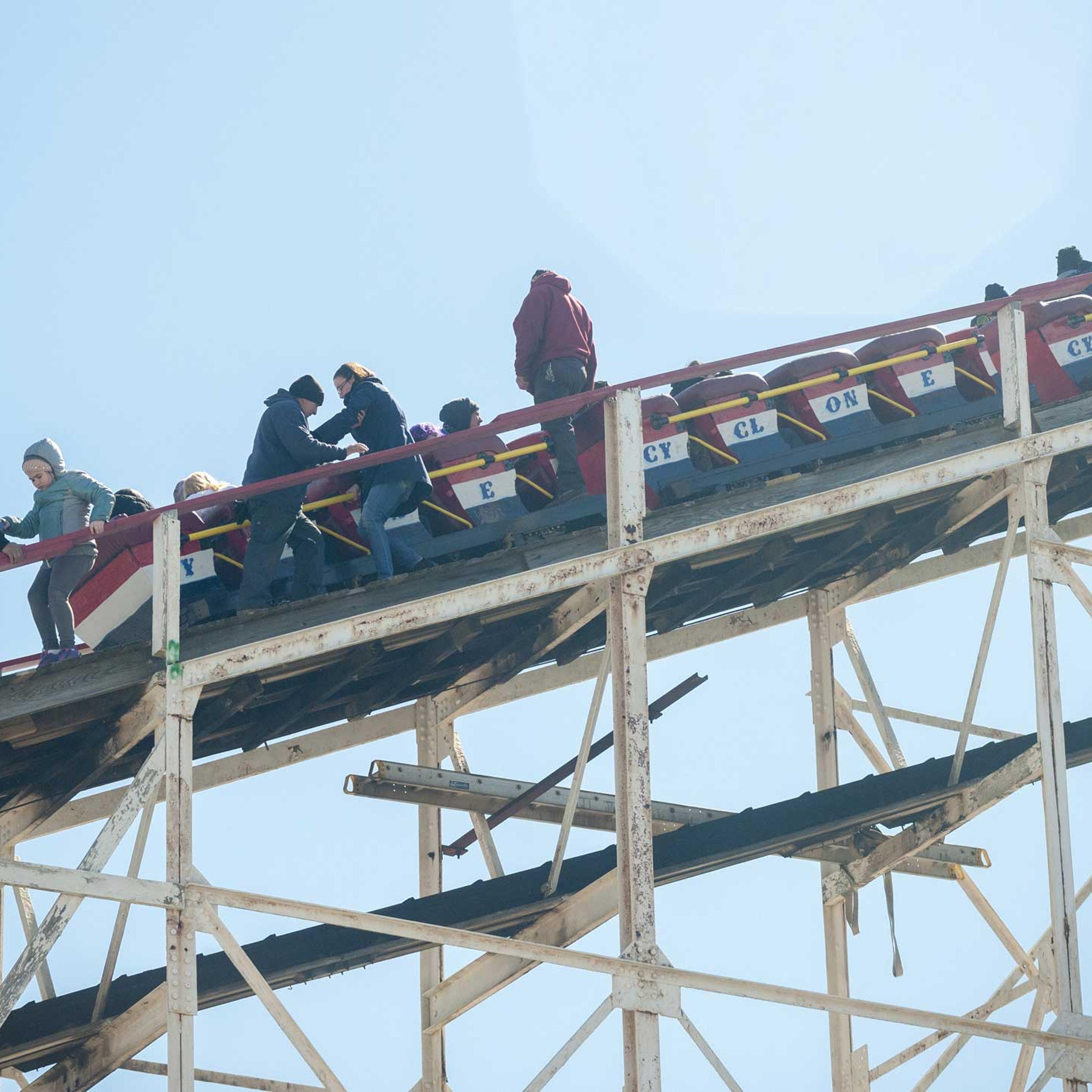 Workers assist thrill seekers on the Luna Park Coney Island Cyclone roller coaster after it got stuck on its inaugural run of the Summer 2015 season, on March 29, 2015 in Brooklyn, N.Y.