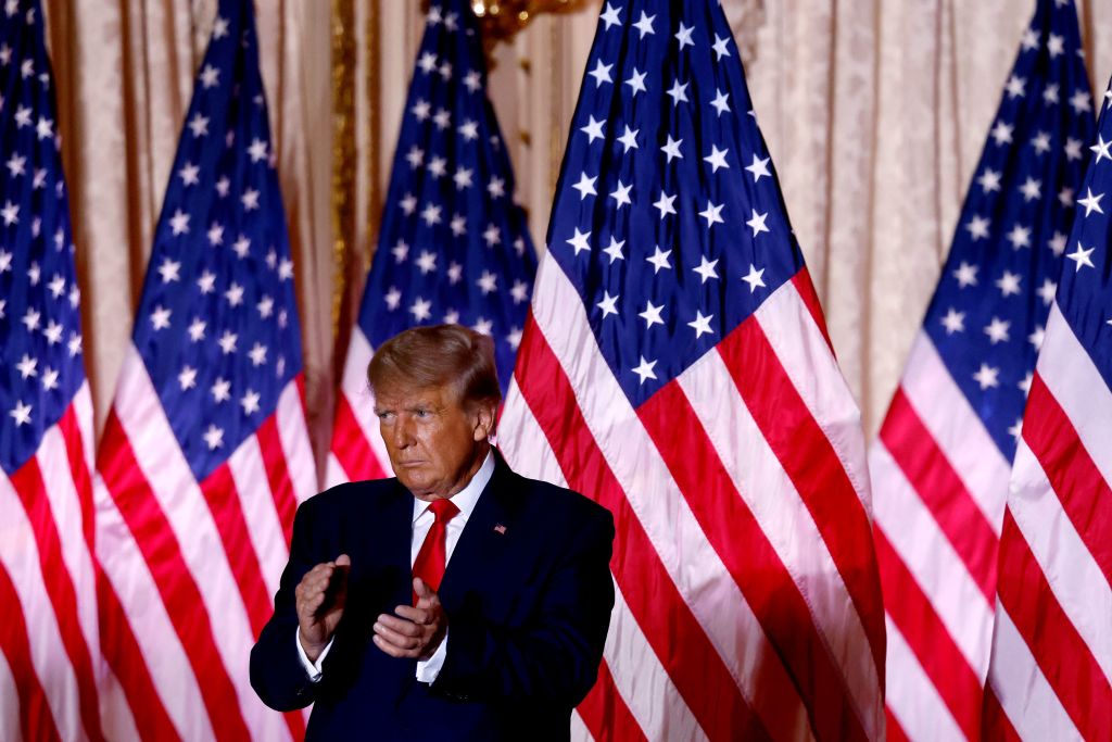 Former U.S. President Donald Trump applauds while speaking at the Mar-a-Lago Club in Palm Beach, Florida.