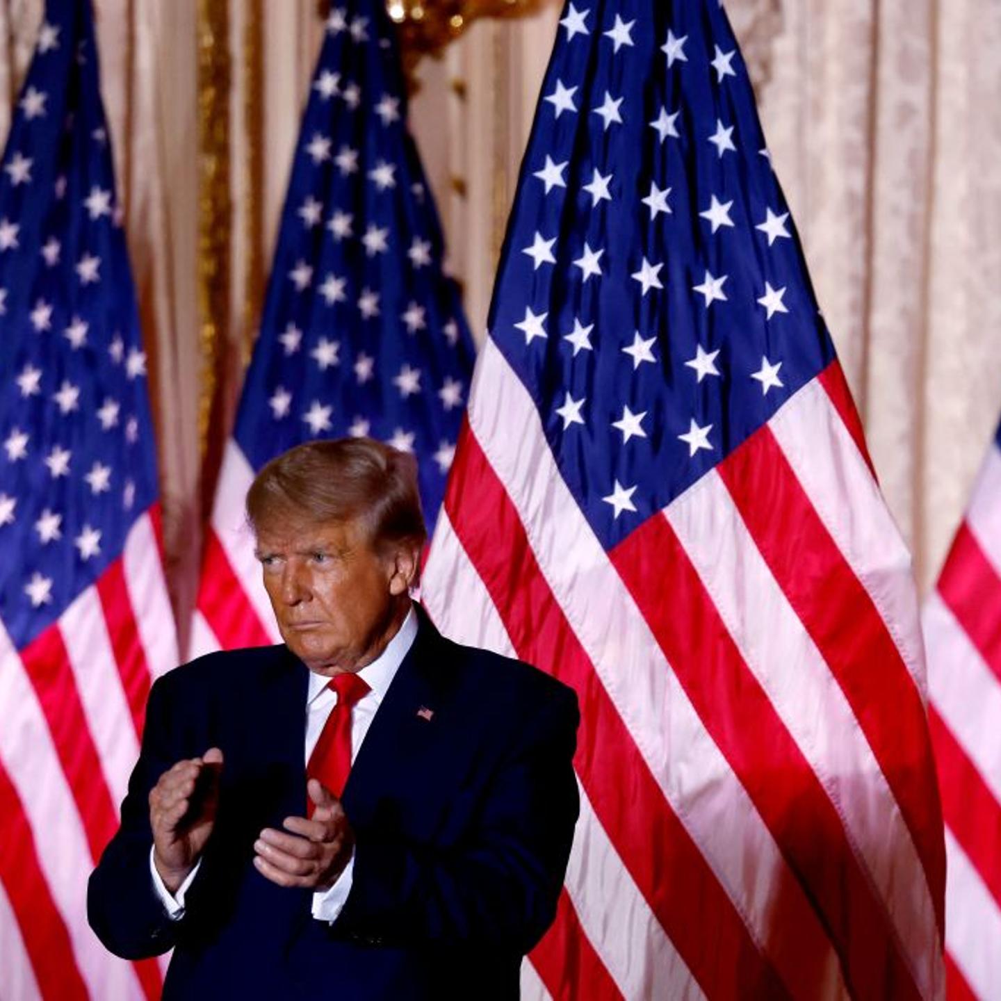 Former U.S. President Donald Trump applauds while speaking at the Mar-a-Lago Club in Palm Beach, Florida.