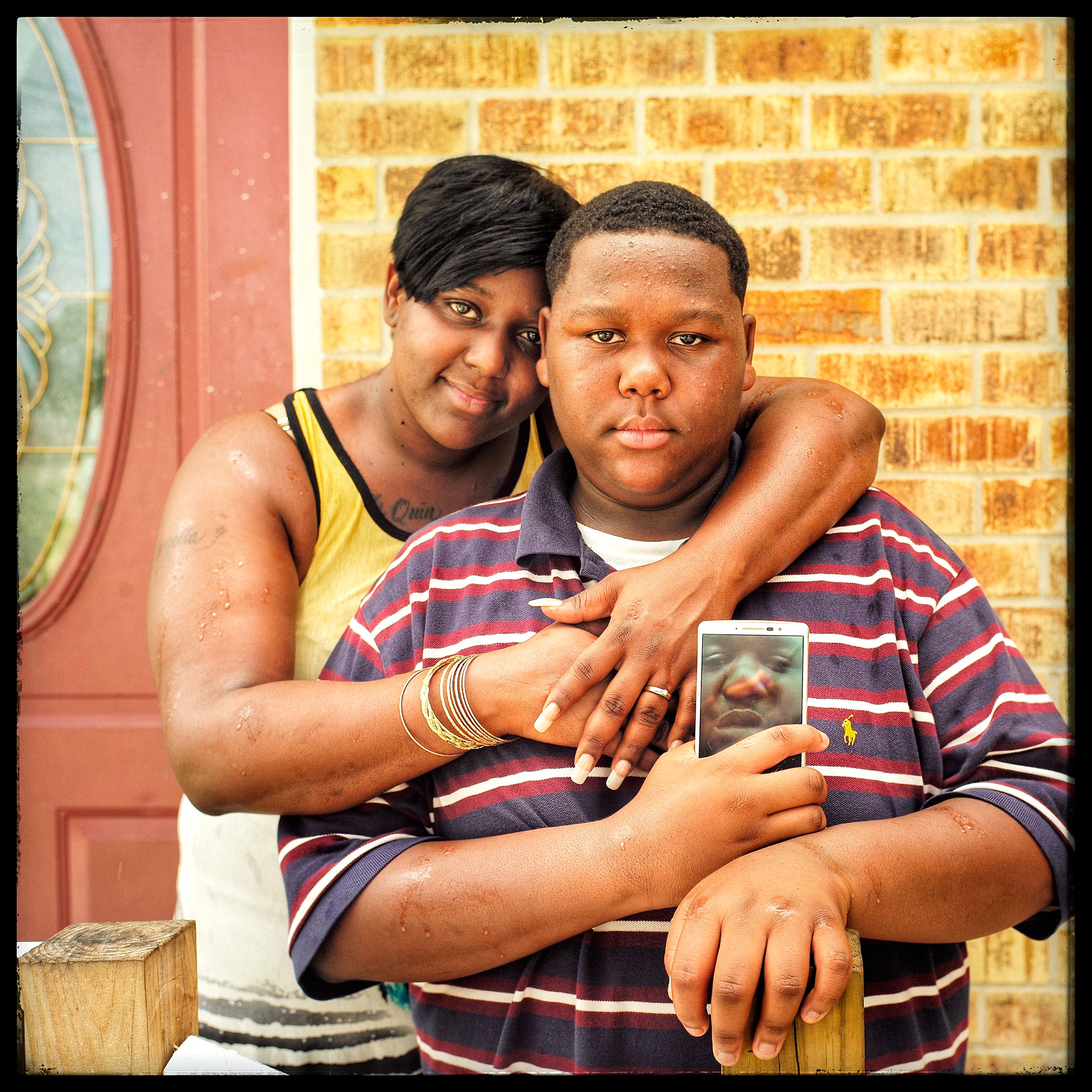 Cameron Sterling and his mother Quinyetta, in Baton Rouge, La., on July 12. Cameron, 15, holds a composite image he made of himself and his father Alton, who was fatally shot by police on July 5. “The police took his phone, so all the pictures he took ar